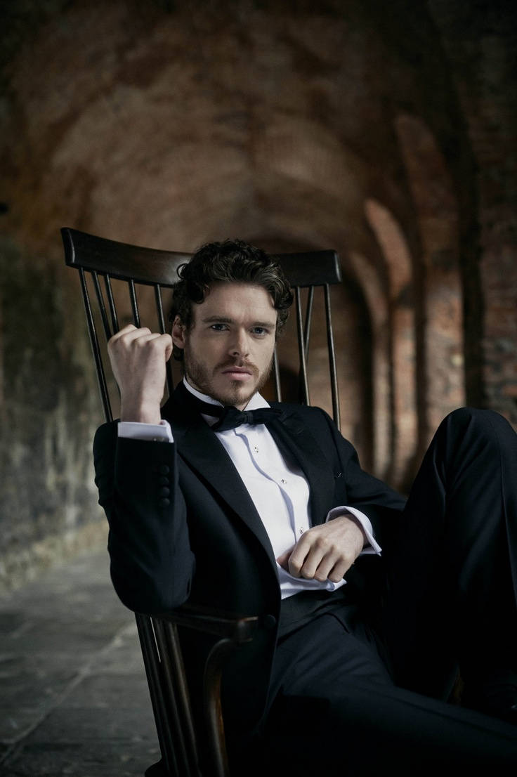 Richard Madden, black tuxedo, wooden chair, SD Phone Wallpaper