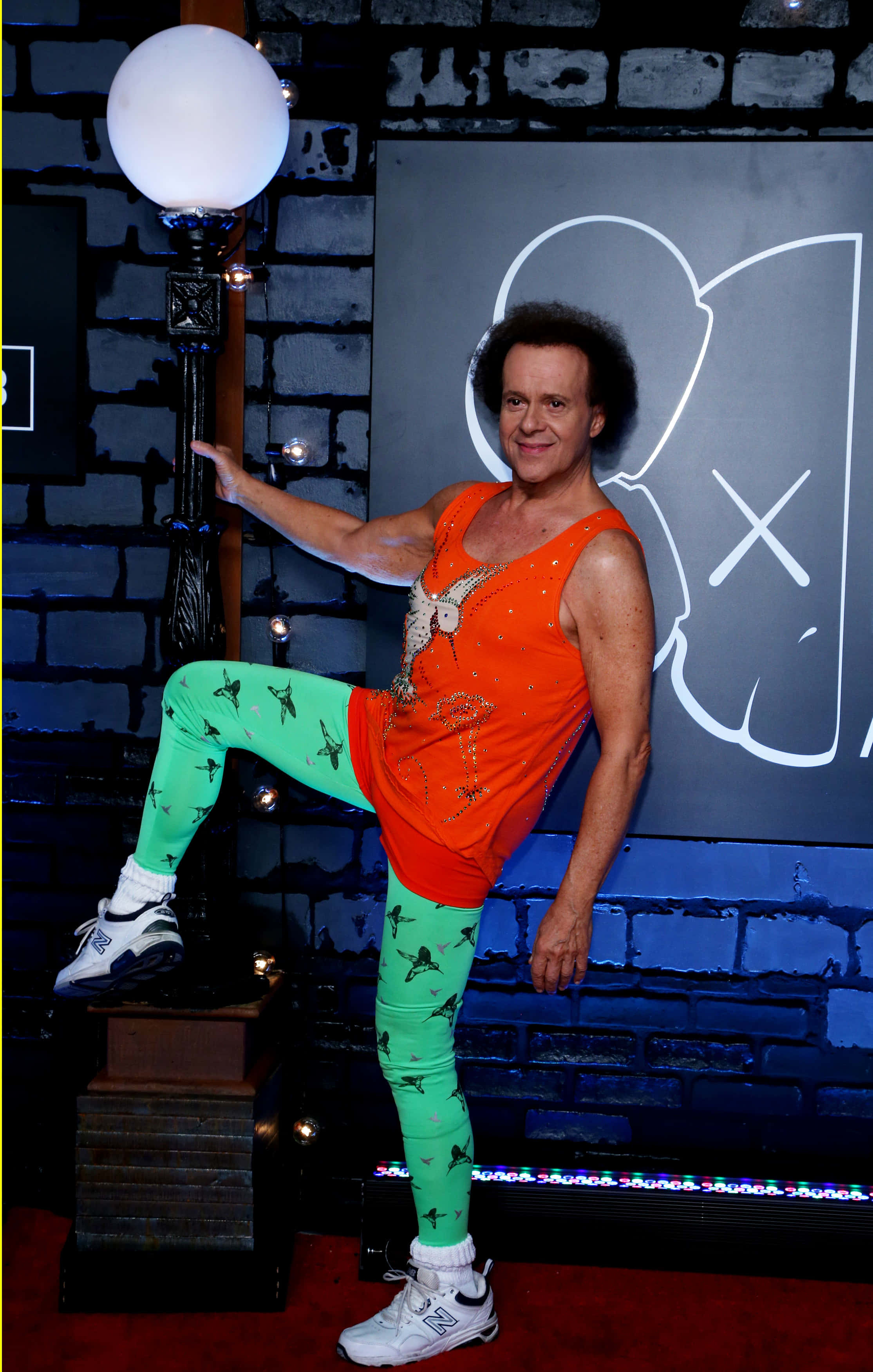 Richard Simmons, bright orange tank top, green patterned leggings, 2K Phone Wallpaper