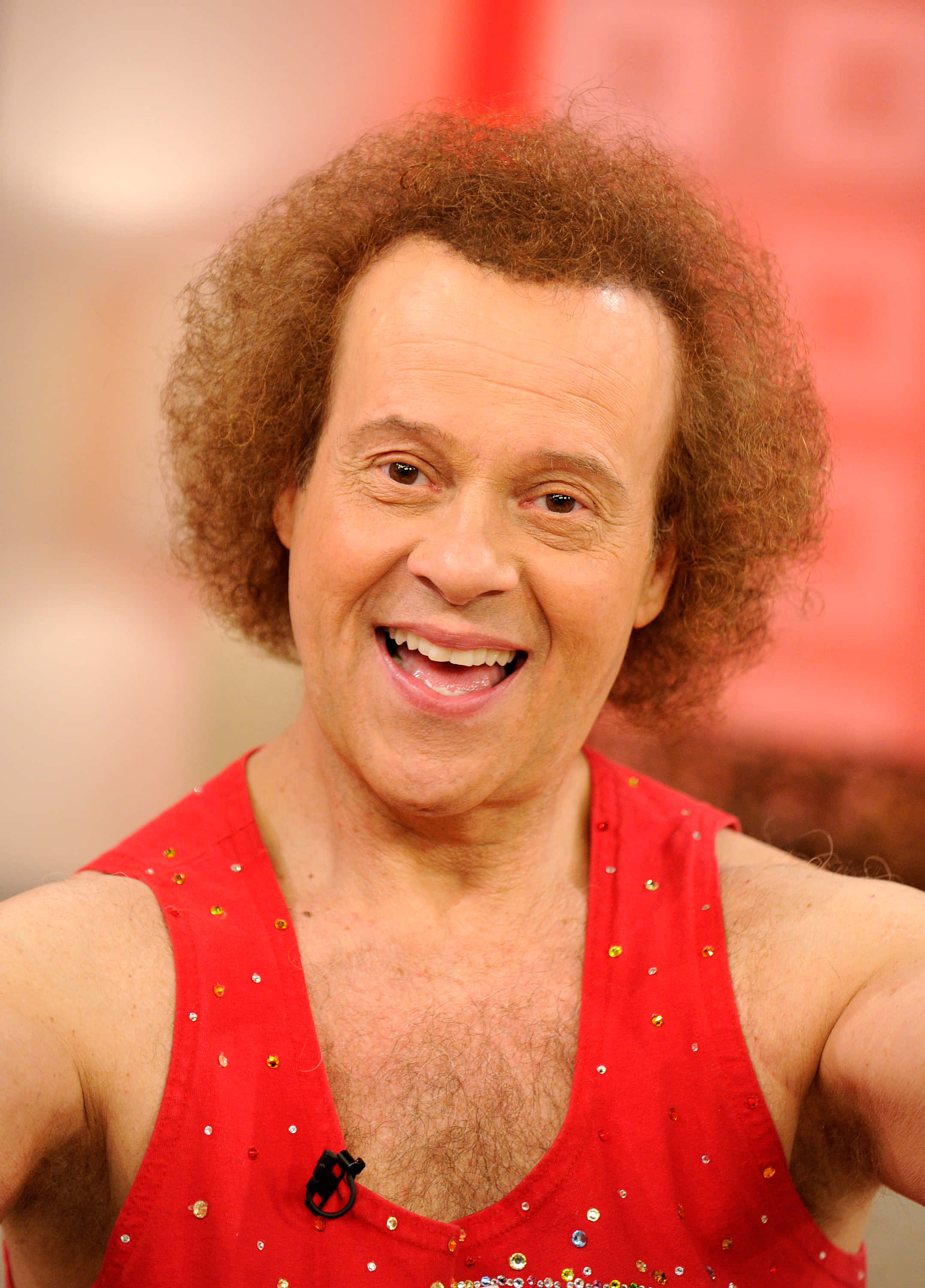 Richard Simmons, red sequined tank top, curly brown hair, 2K Phone Wallpaper