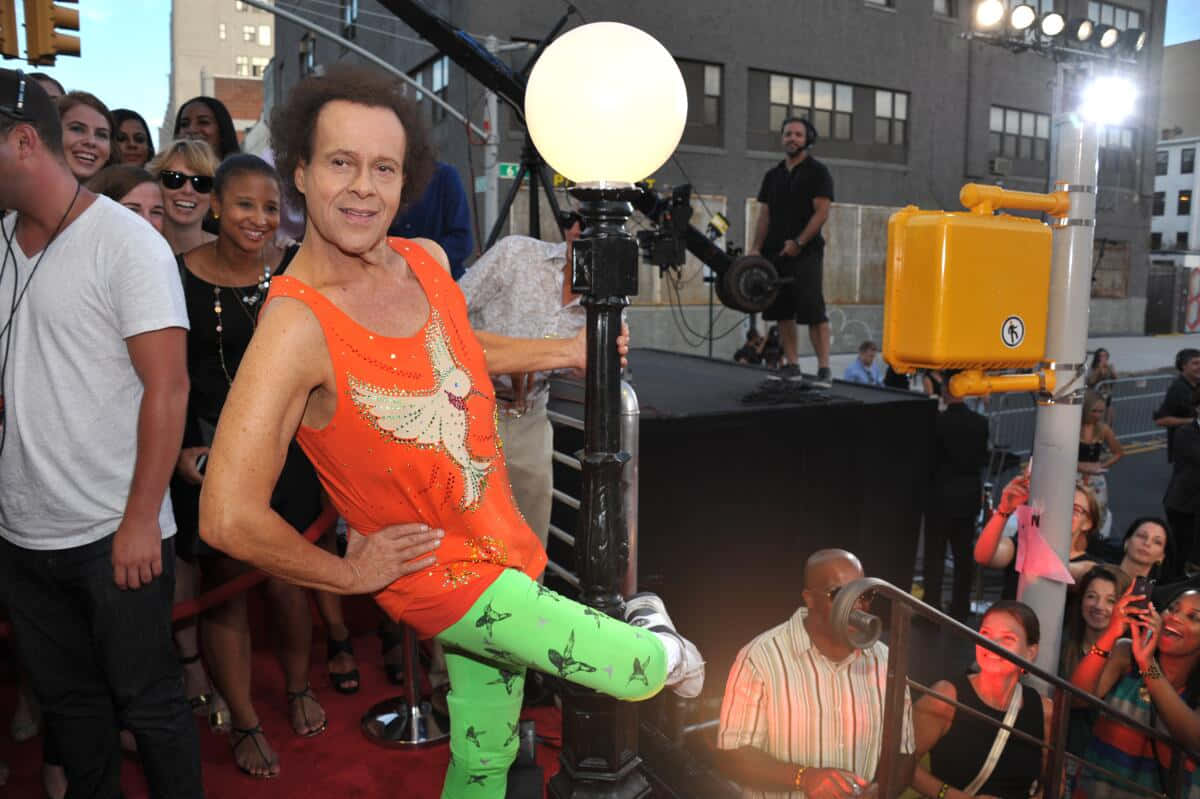 Richard Simmons, bright orange tank top, white dove, SD Desktop Wallpaper