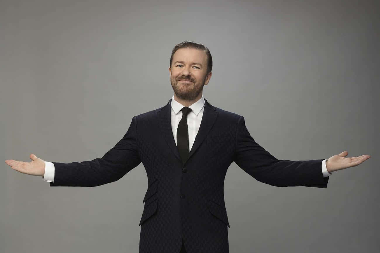 Ricky Gervais, dark patterned suit, plain gray studio background, HD Desktop Wallpaper