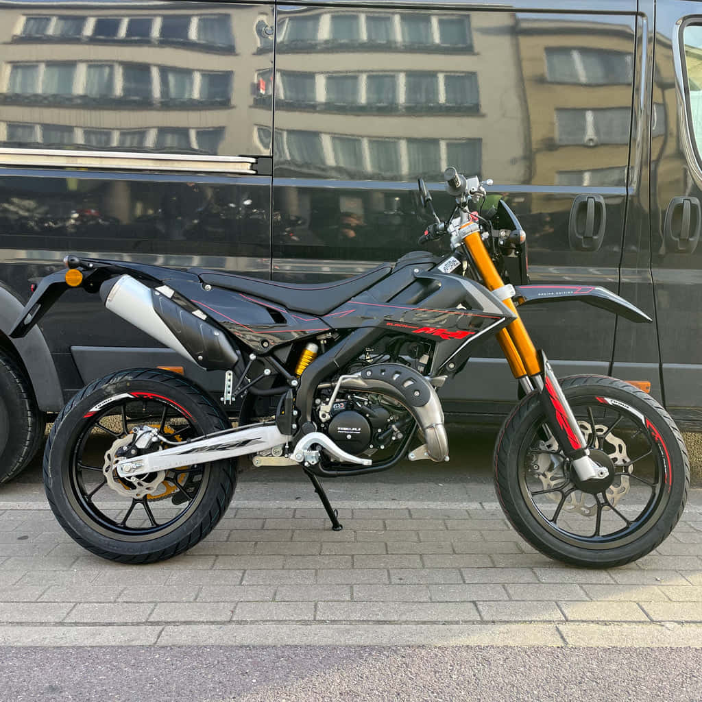 Rieju, sleek black and orange sport motorcycle, paved sidewalk, SD Desktop Wallpaper