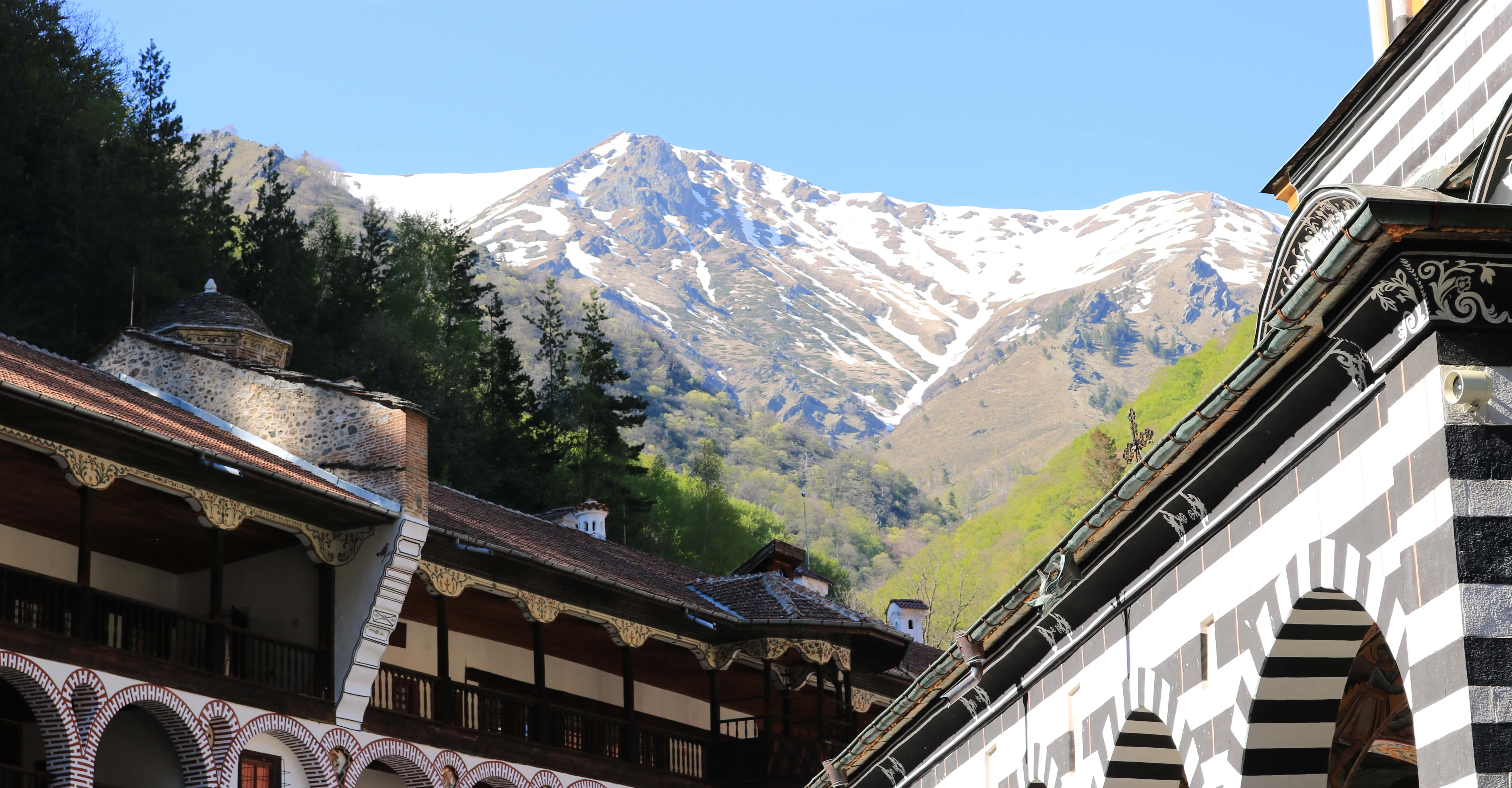 Rila Monastery, snow-capped mountains, striped arches, 5K Desktop Wallpaper