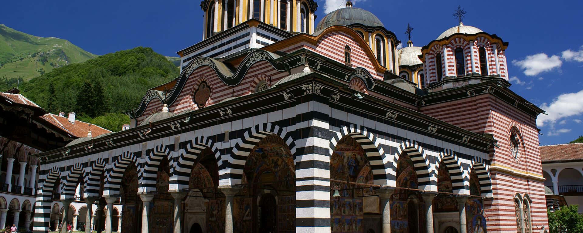 Rila Monastery, black and white striped arches, pink domes, Full HD Desktop Wallpaper