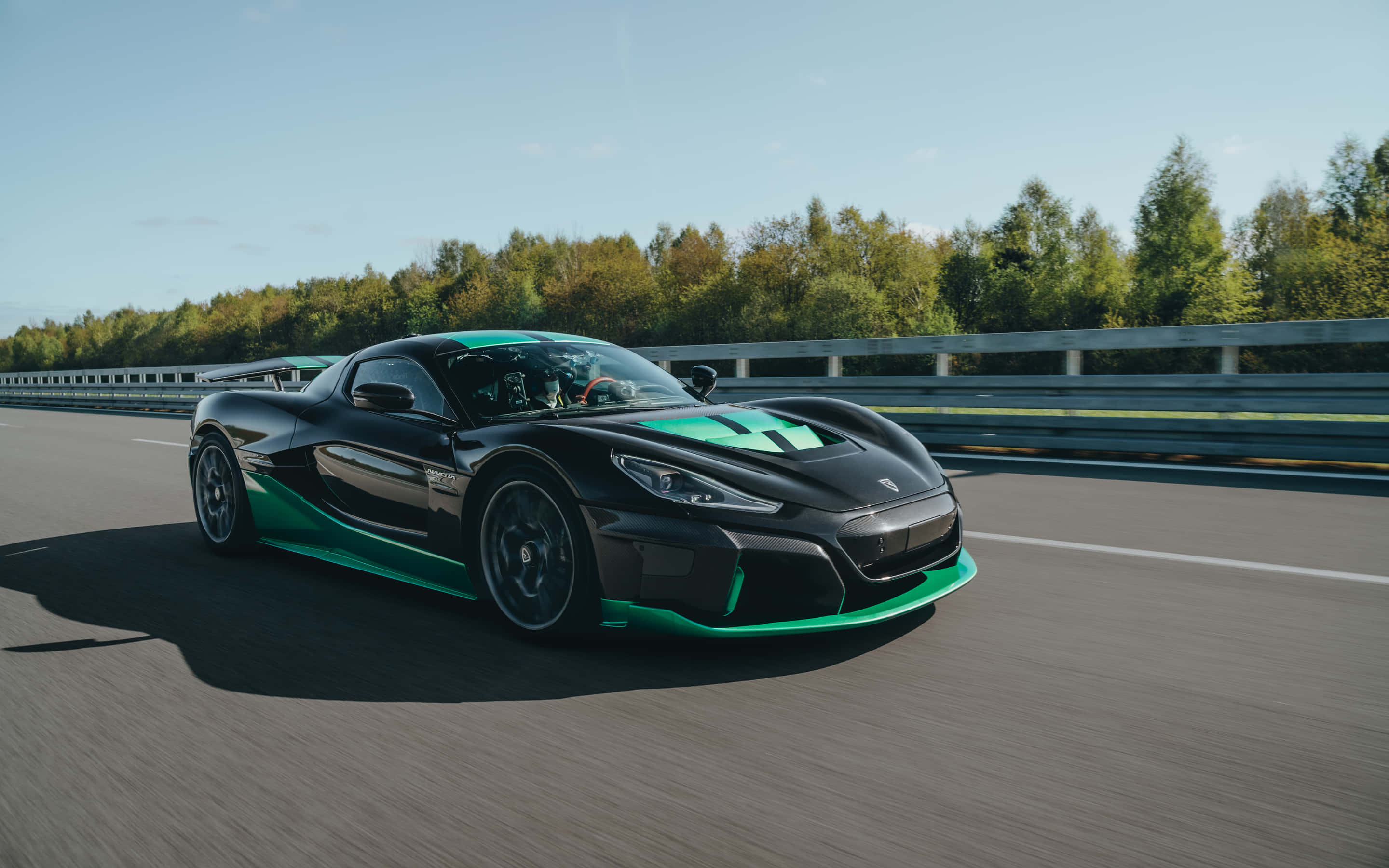 Rimac Nevera, sleek black and green hypercar, sunlit highway, 2K Desktop Wallpaper