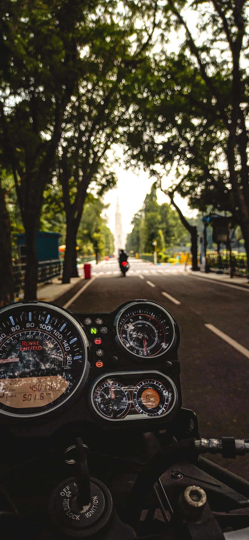 motorcycle dashboard, tree-lined road, distant monument, HD Phone Wallpaper