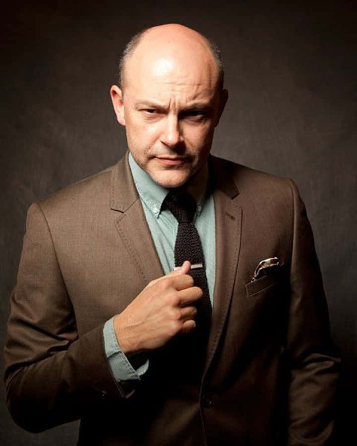Rob Corddry, brown suit, dark studio backdrop, SD Phone Wallpaper