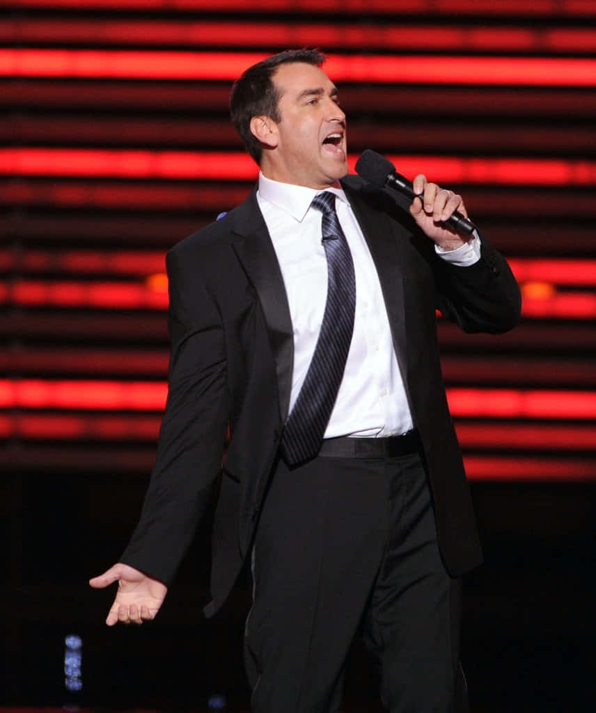 Rob Riggle, black suit, microphone, SD Phone Wallpaper