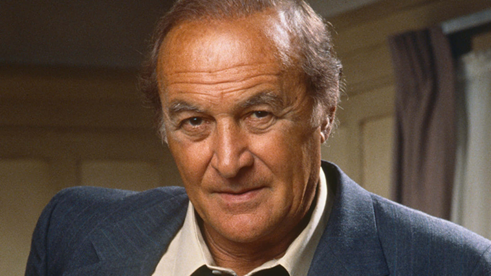 Robert Loggia, blue suit, warmly lit indoor setting, Full HD Desktop Wallpaper