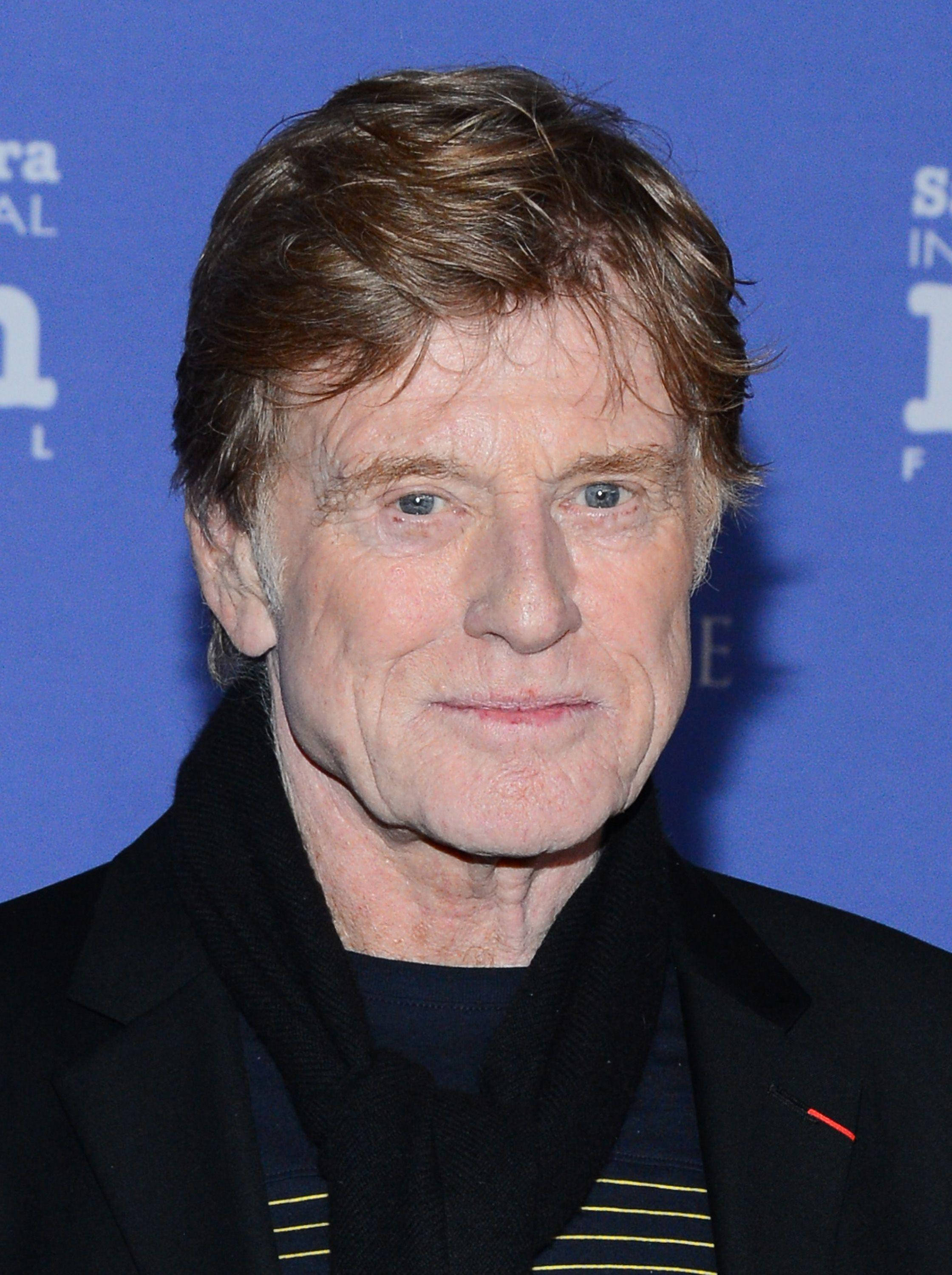 Robert Redford, blue background, black coat, 2K Phone Wallpaper