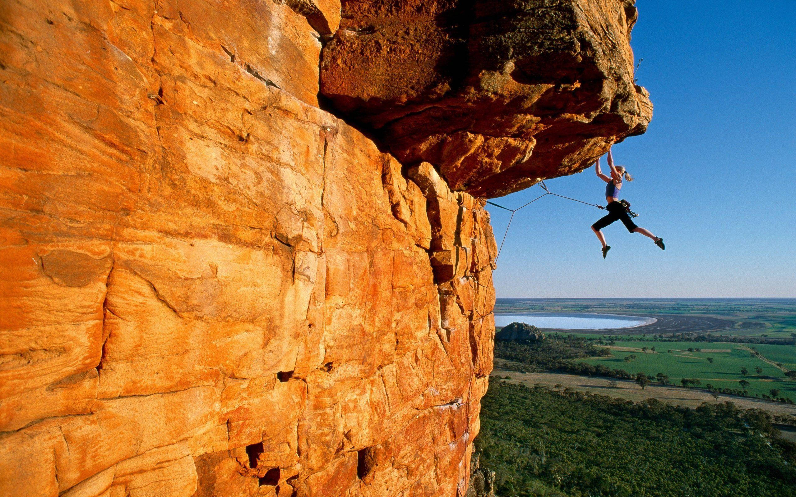 brae, woman rock climbing, massive orange cliff, 2K Desktop Wallpaper