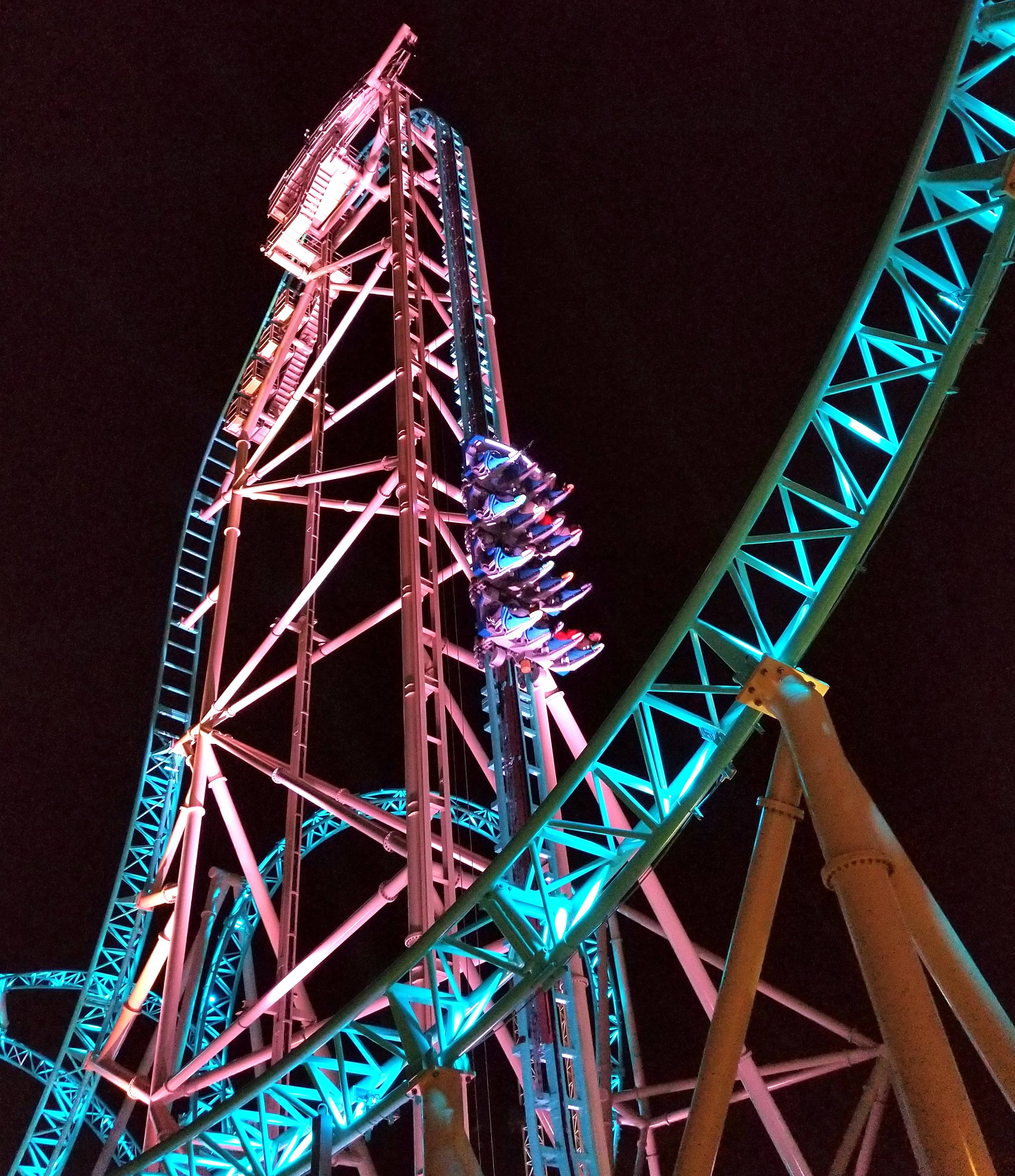 roller coaster, ascending wagons, pink-lit tower, 2K Phone Wallpaper