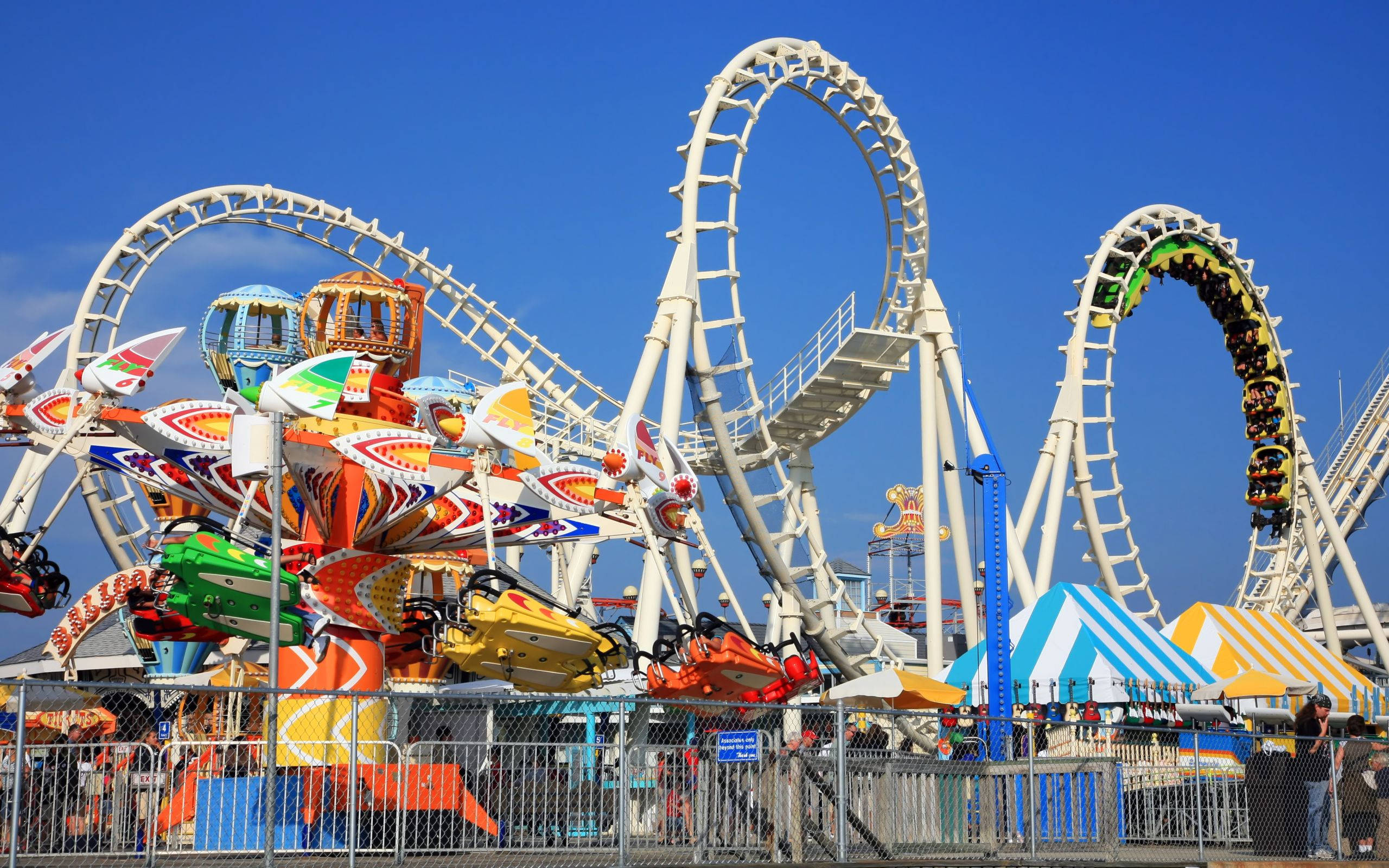 white roller coaster, clear blue sky, vibrant amusement park, 2K Desktop Wallpaper