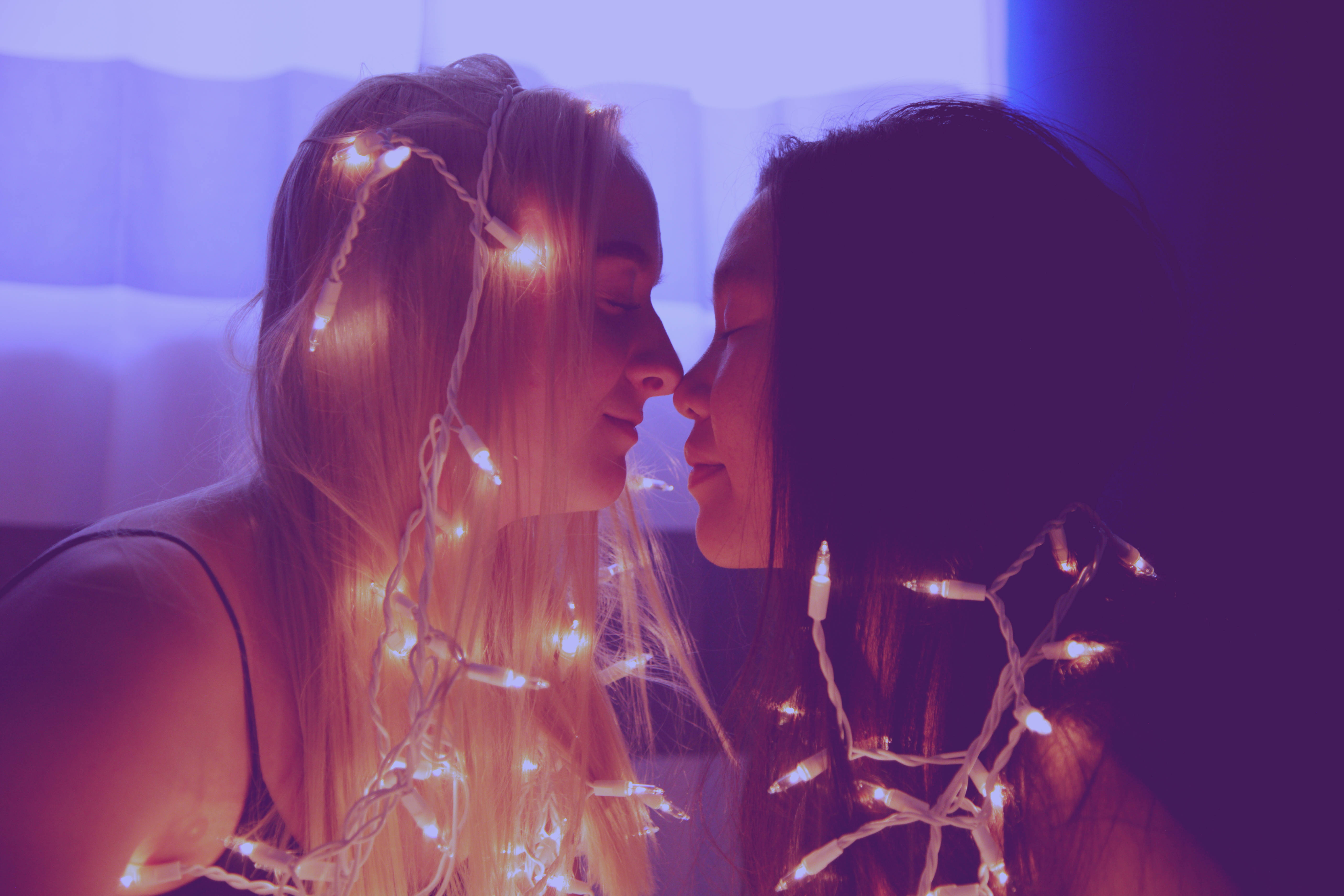 lesbian couple, fairy lights, purple ambient lighting, 5K Desktop Wallpaper