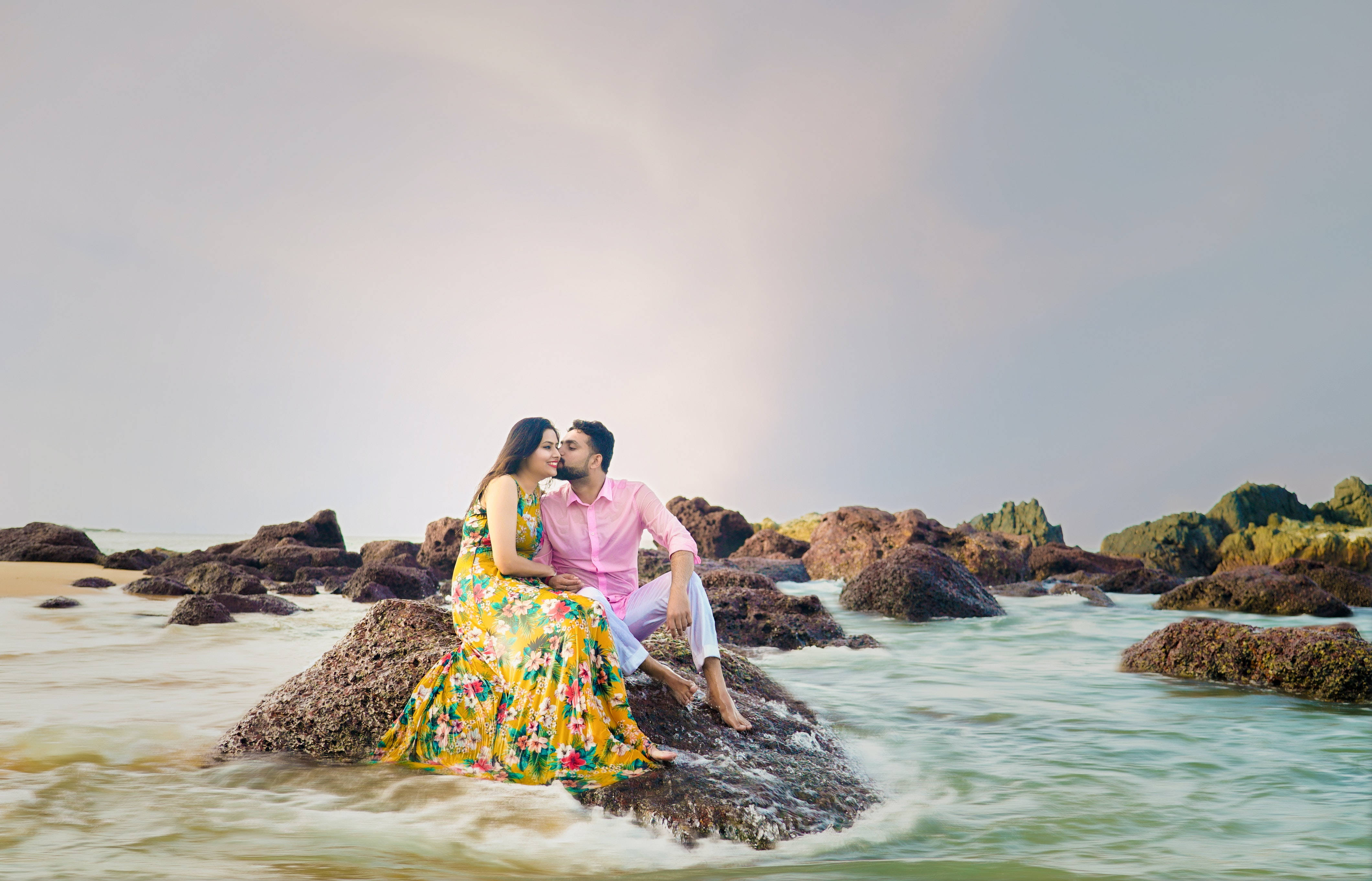beach boulder, vibrant attire, gentle waves, 4K Desktop Wallpaper