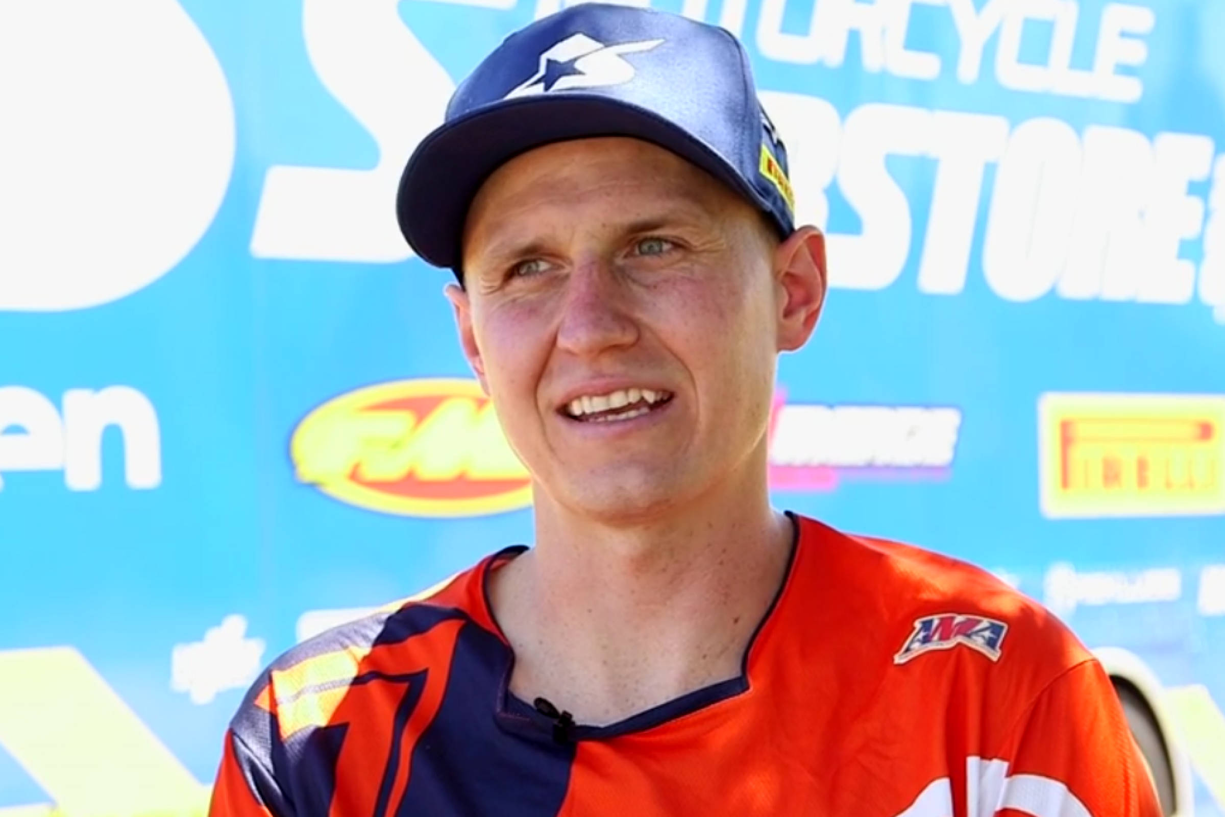 Ronnie Mac, orange and blue gear, bright blue sponsor backdrop, Full HD Desktop Wallpaper