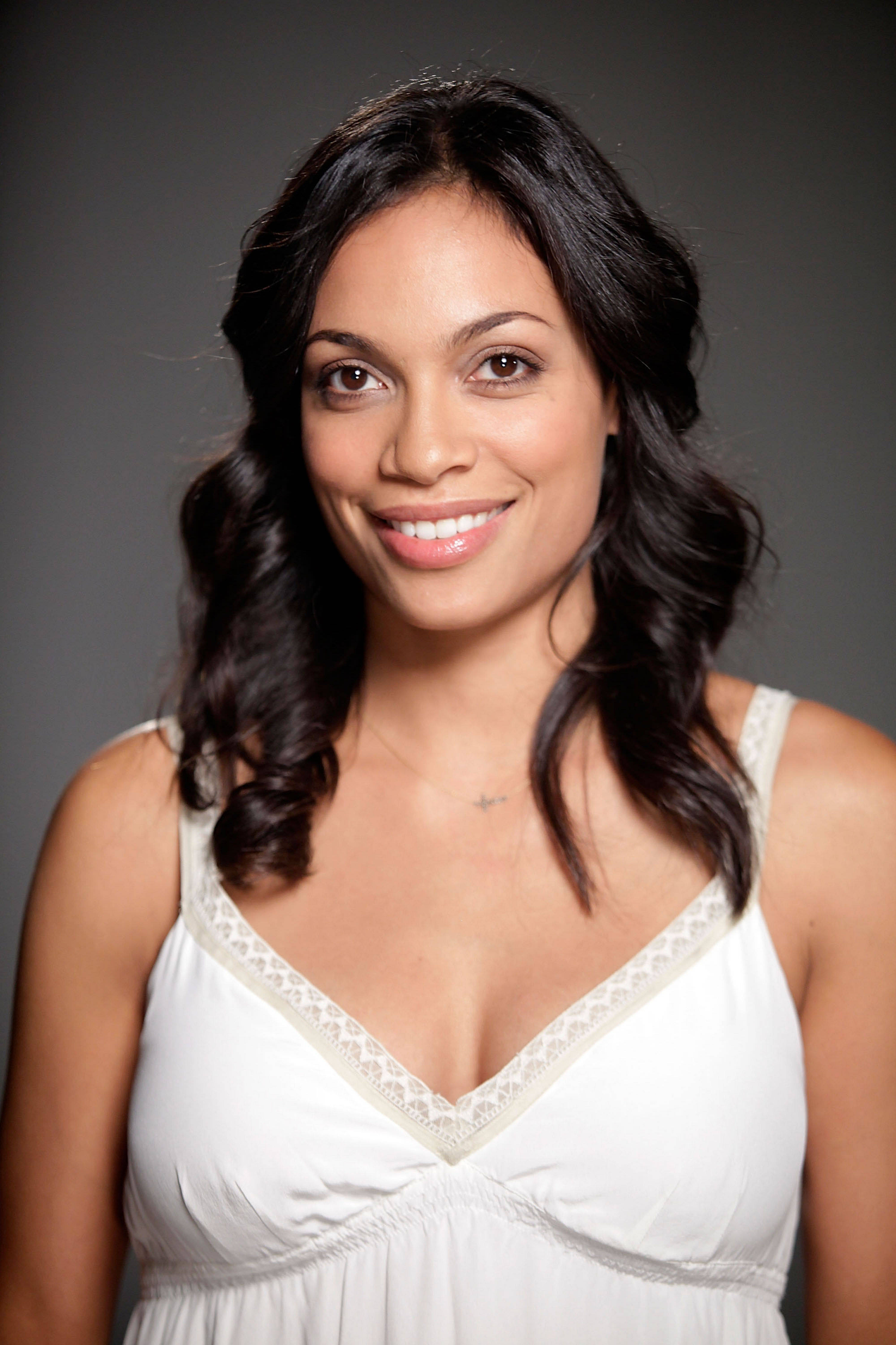 Rosario Dawson, white lace-trimmed top, neutral gray studio background, 4K Phone Wallpaper
