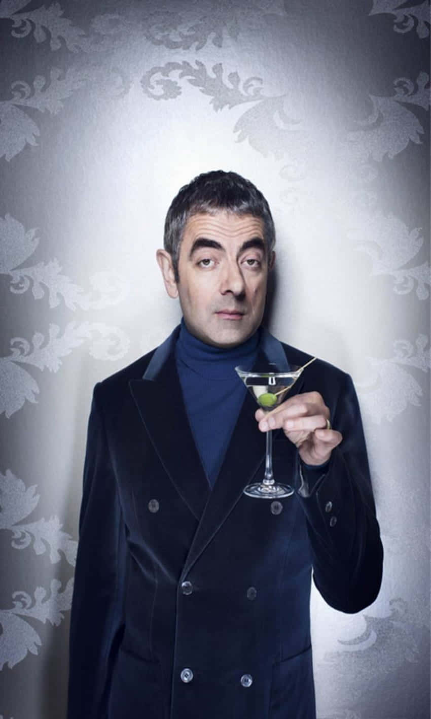 Rowan Atkinson, dark velvet double-breasted coat, martini glass with a green olive, HD Phone Wallpaper