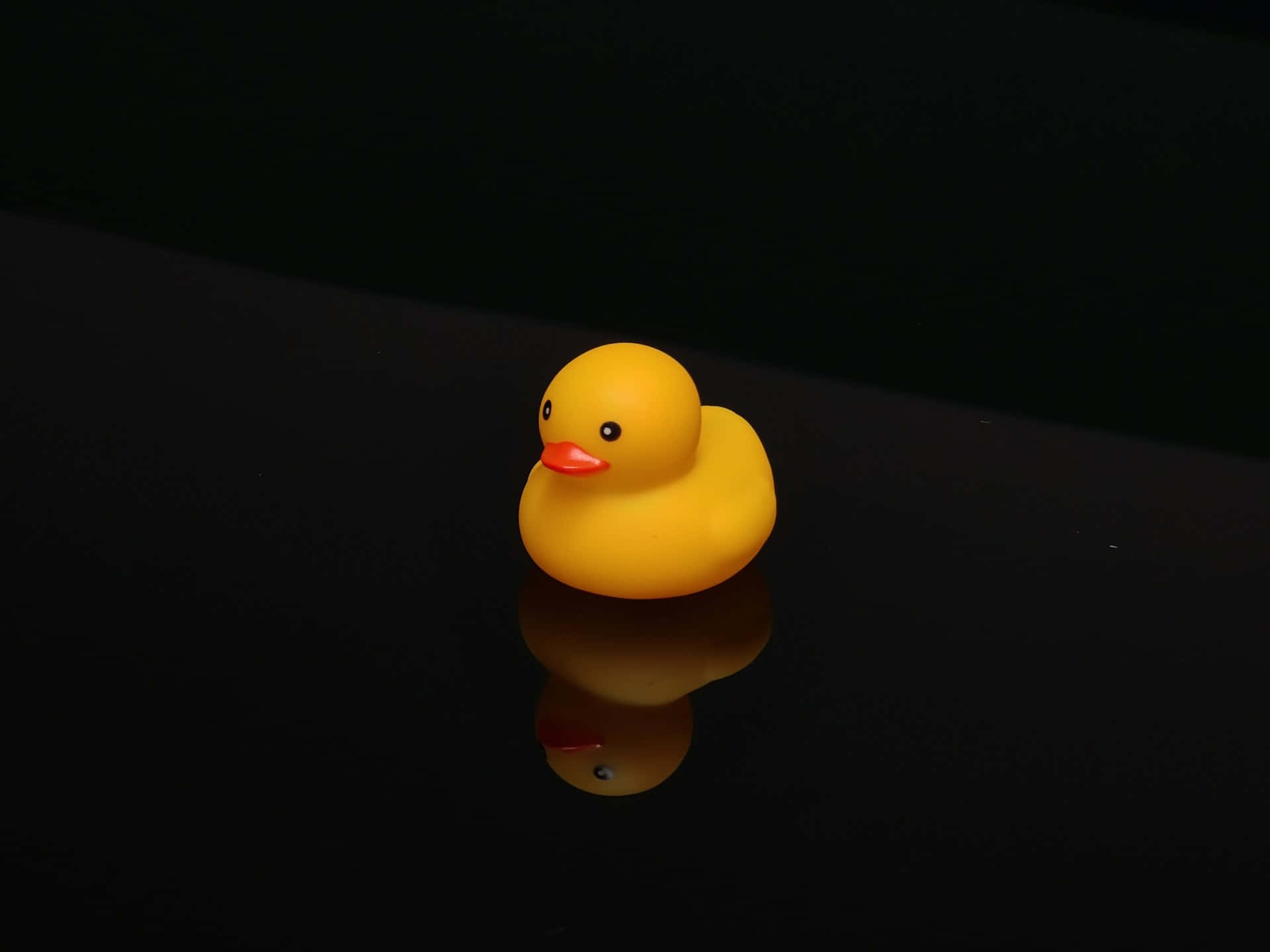 yellow rubber duck, orange beak, glossy black surface, Full HD Desktop Wallpaper