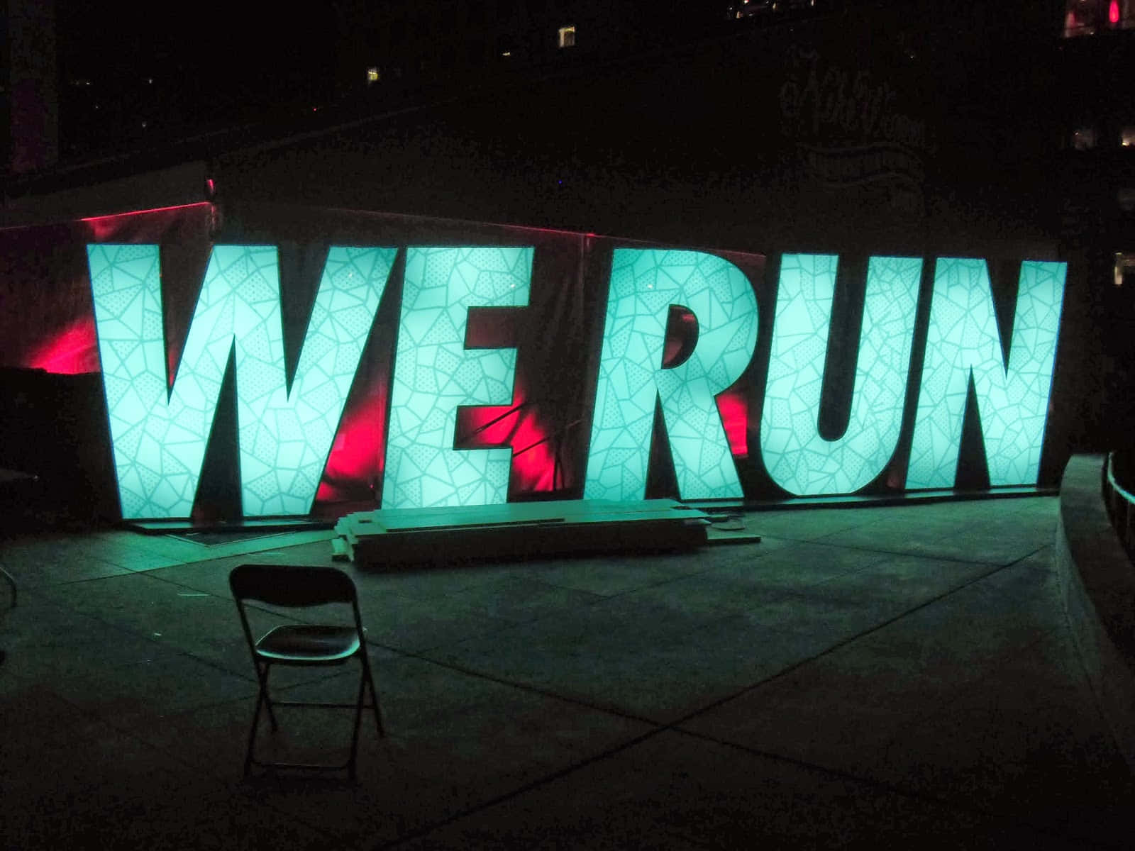 WE RUN, glowing teal letters, red backlighting, HD Desktop Wallpaper