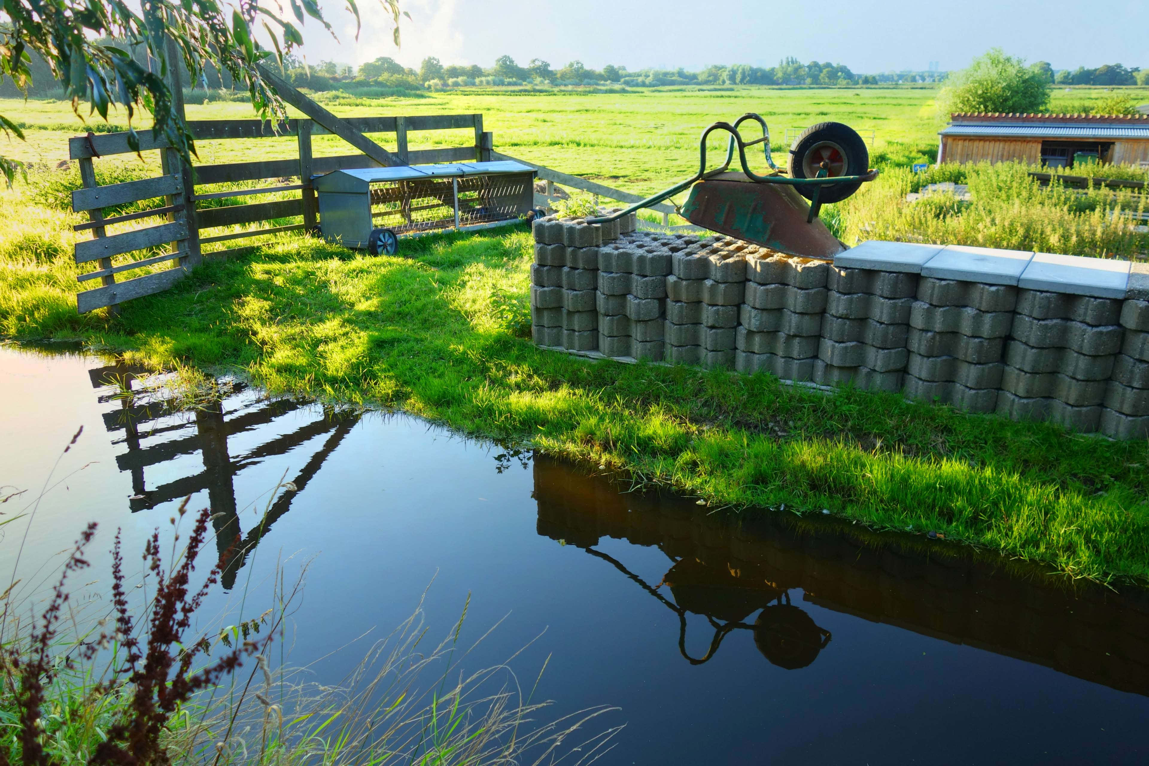 rustic wooden fence, overturned wheelbarrow, calm water, 4K Desktop Wallpaper