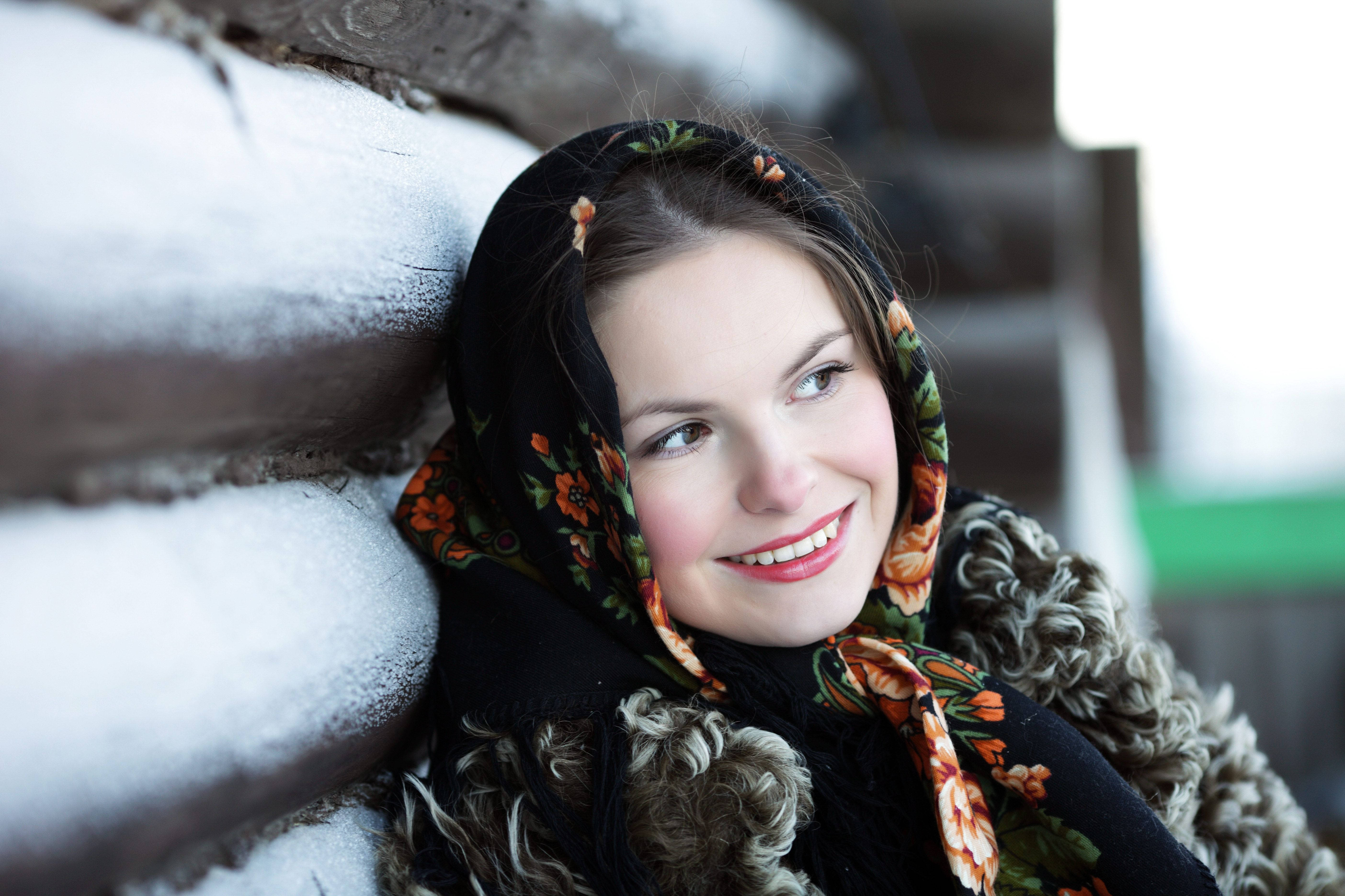 Russian Girl, floral headscarf, snow-dusted wooden log cabin wall, 5K Desktop Wallpaper