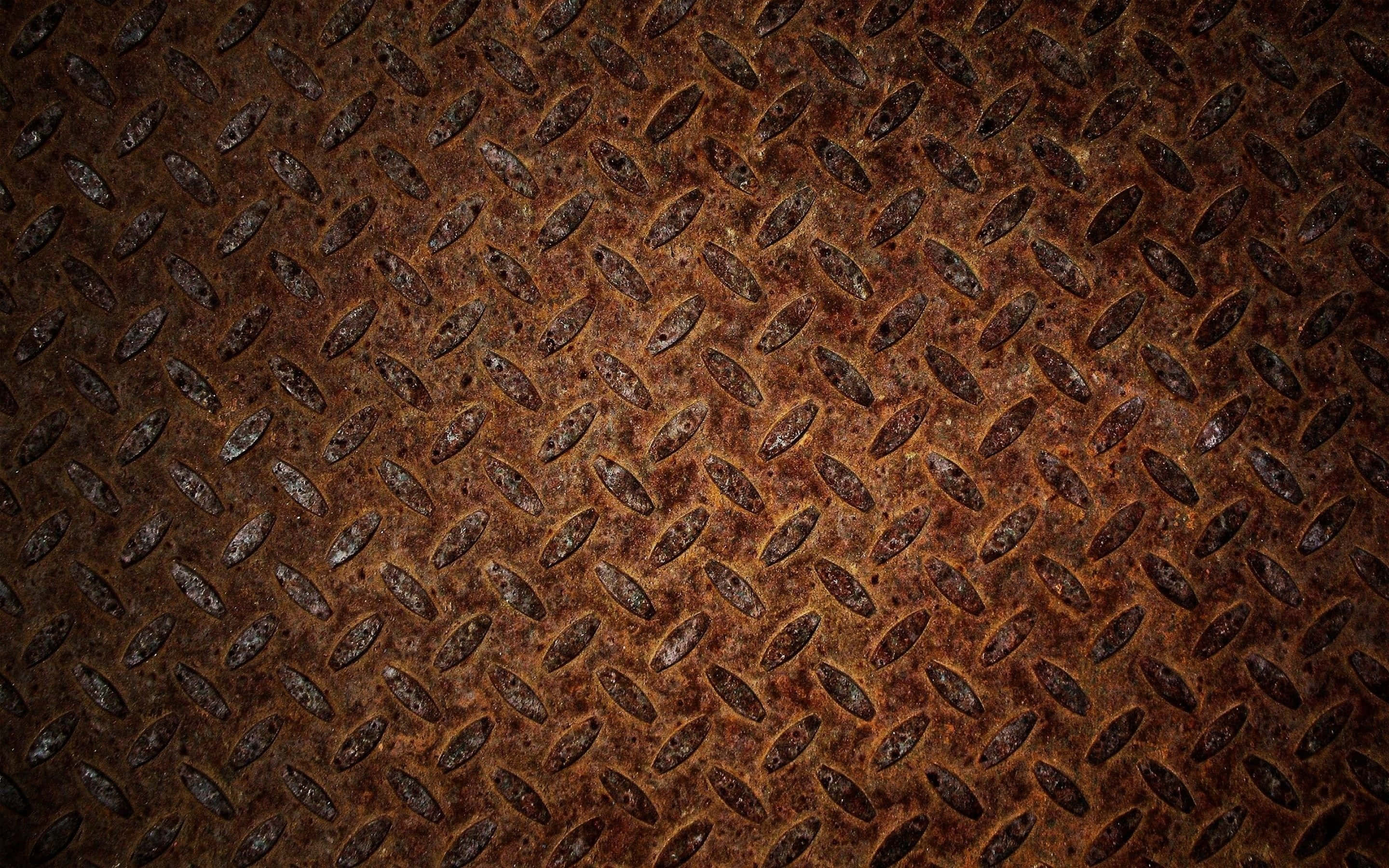 rusted diamond plate metal, textured brown and orange patina, close-up, 2K Desktop Wallpaper