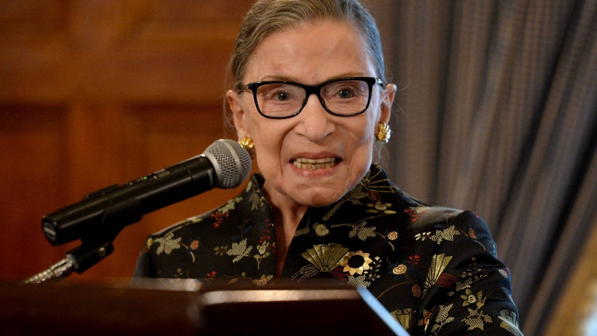 Ruth Bader Ginsburg, gold floral dress, microphone, Full HD Desktop Wallpaper