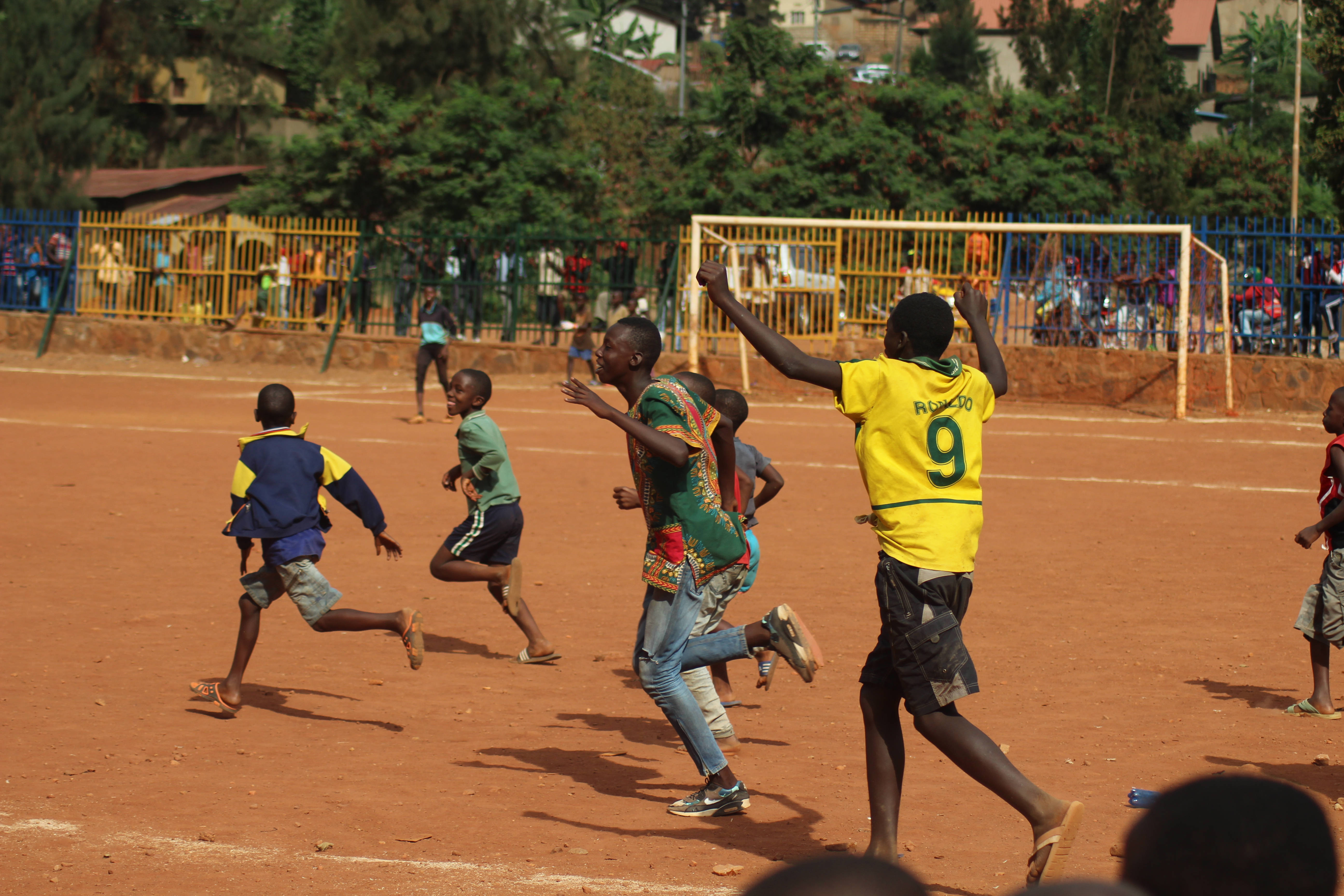 Rwanda, soccer match, dusty red clay field, 5K Desktop Wallpaper