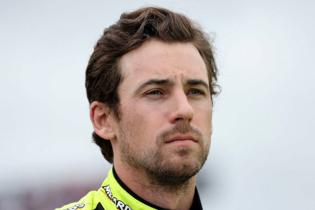 Ryan Blaney, bright yellow racing suit, soft gray background, SD Desktop Wallpaper