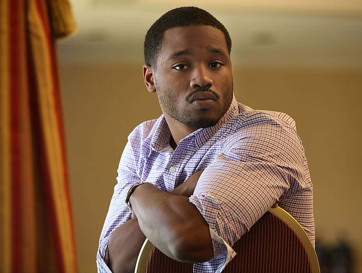 Ryan Coogler, checkered shirt, chair with arms crossed, SD Desktop Wallpaper