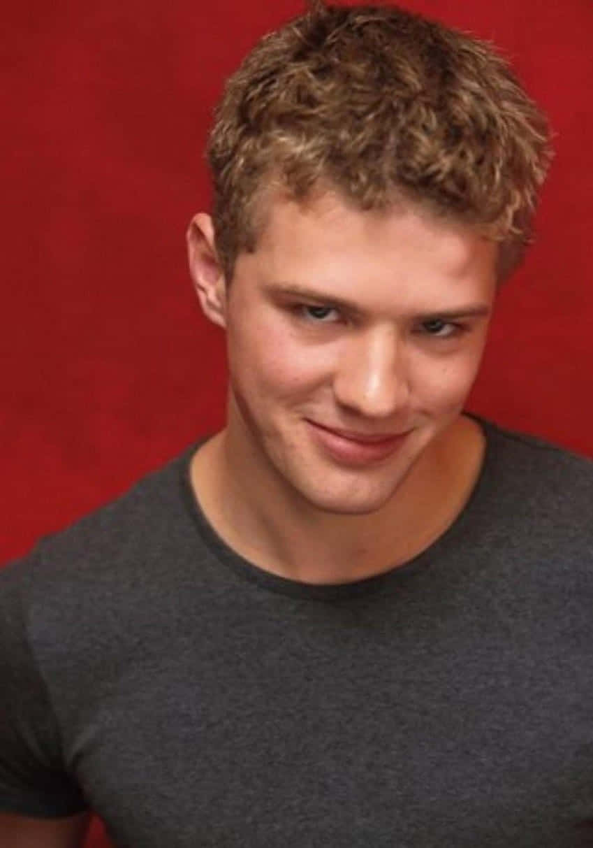 Ryan Phillippe, tousled blond hair, vivid red backdrop, SD Phone Wallpaper