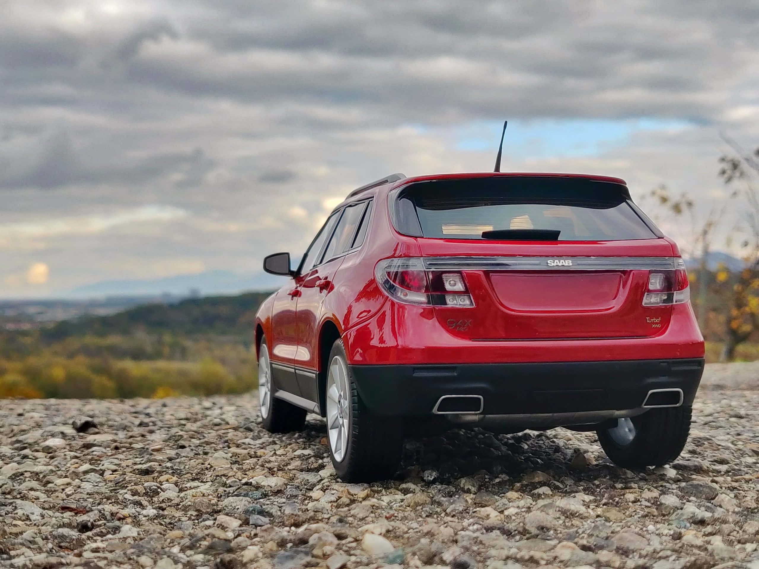 Saab 9-4x, glossy red, gravel overlook, 2K Desktop Wallpaper