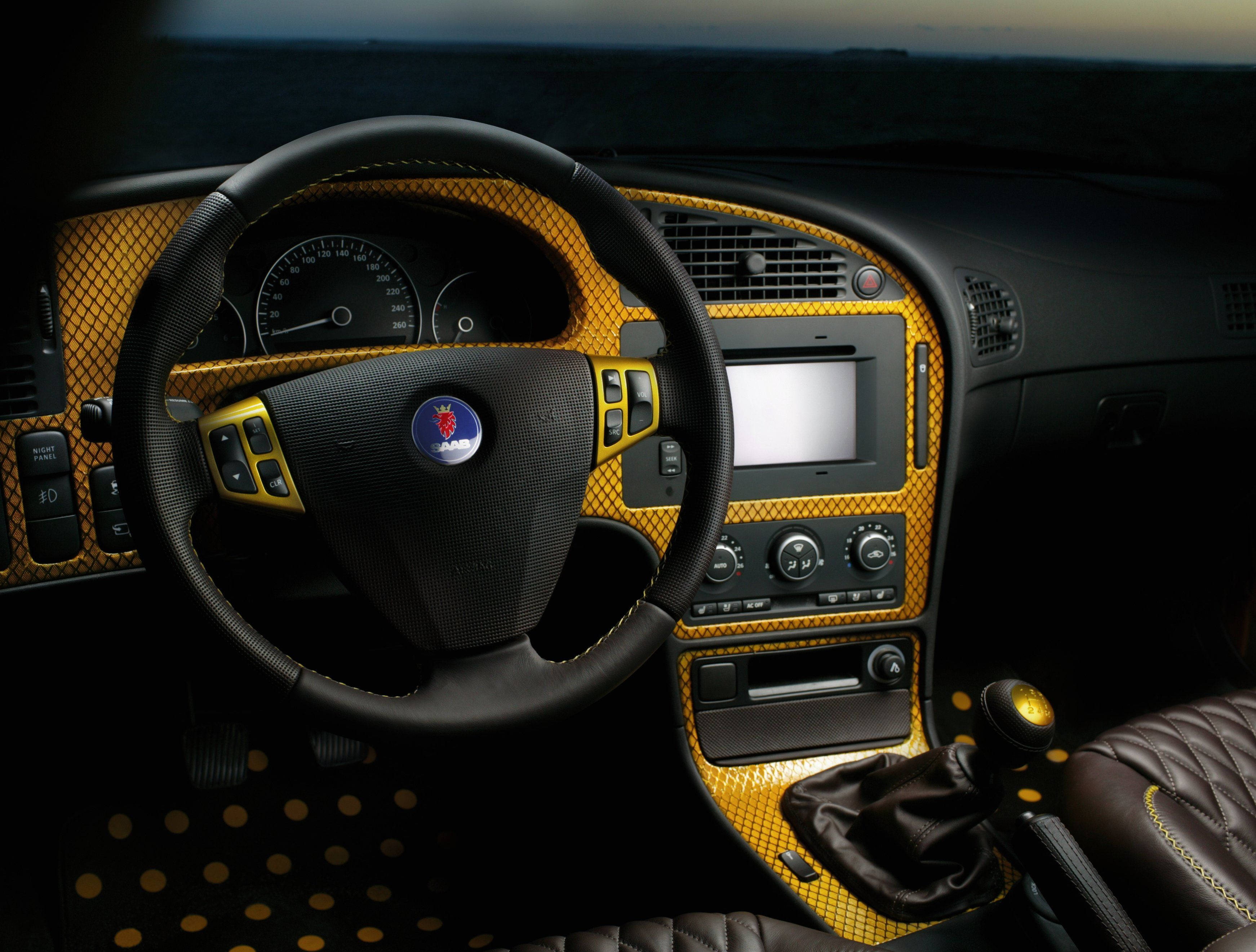 2007 Saab 9-5, black leather, gold mesh accents, 2K Desktop Wallpaper