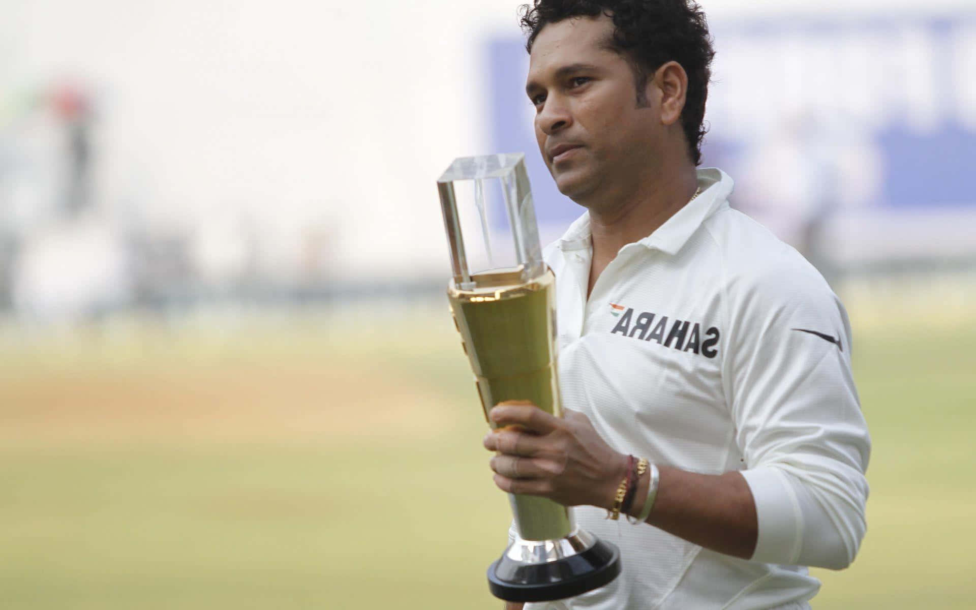 Sachin Tendulkar, golden trophy, sunlit green field, Full HD Desktop Wallpaper