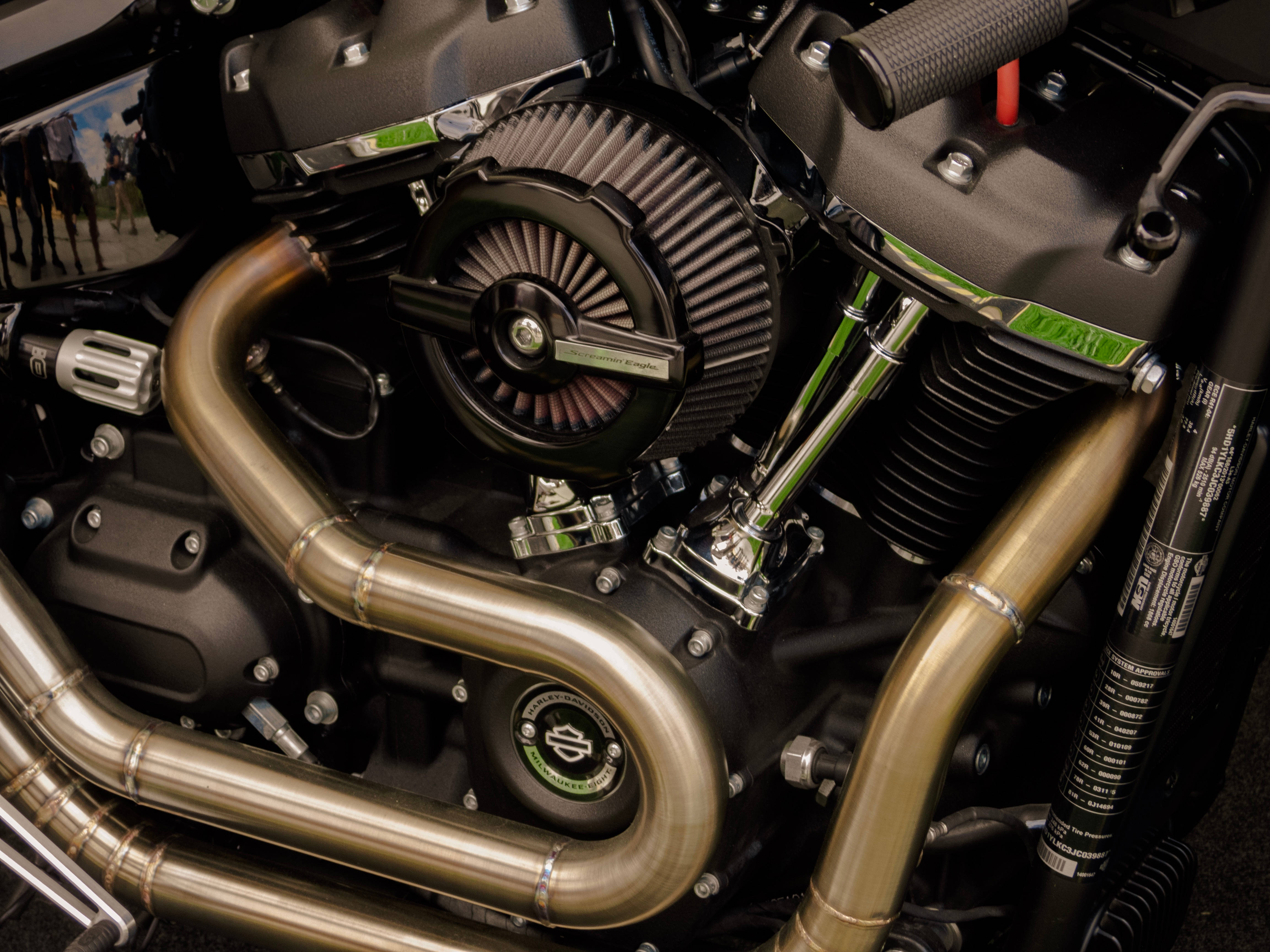Close-up of a Harley-Davidson motorcycle engine with gleaming chrome pipes and black air filter., 4K Desktop Wallpaper