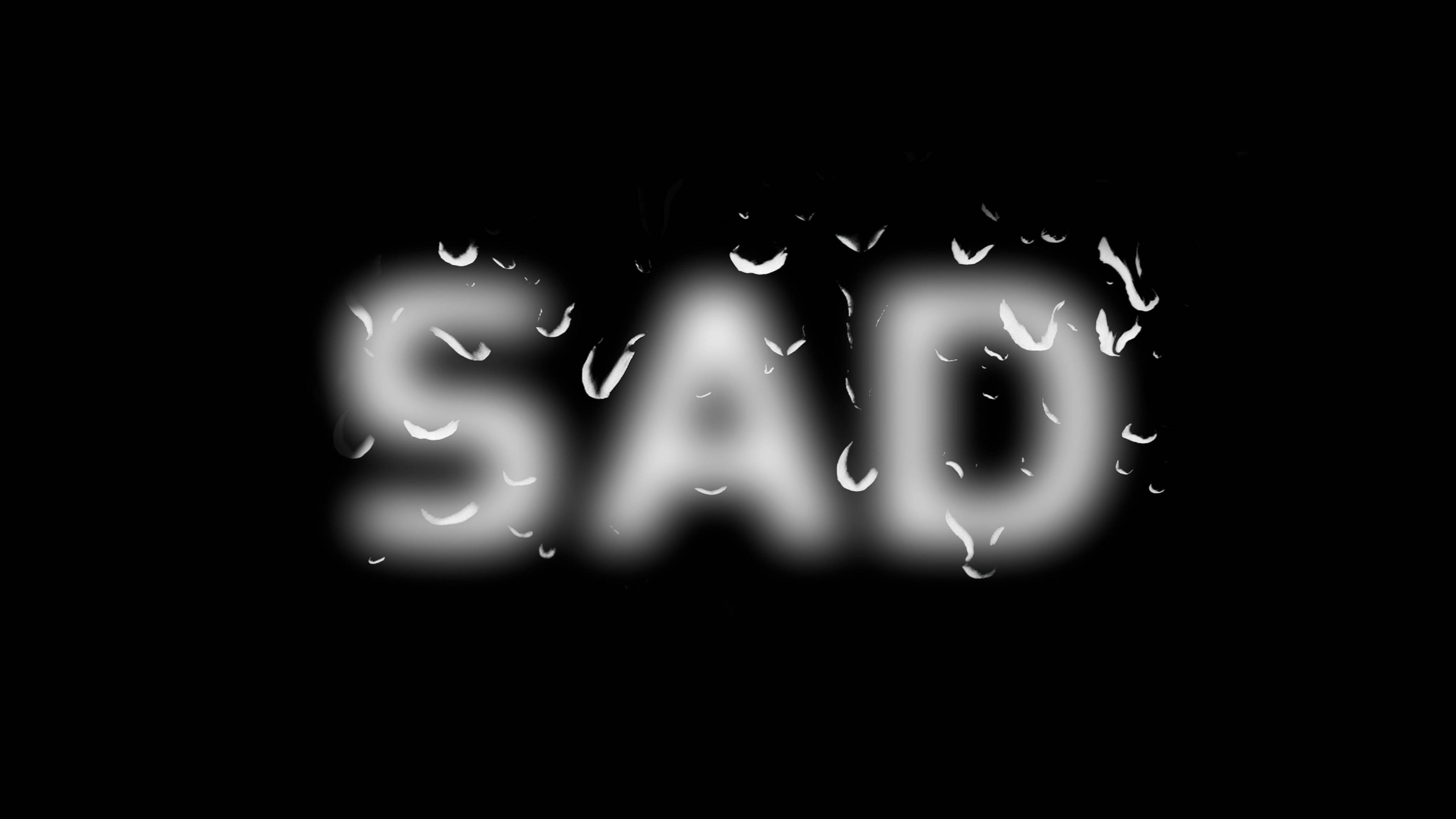 SAD, glows softly, black background, 4K Desktop Wallpaper