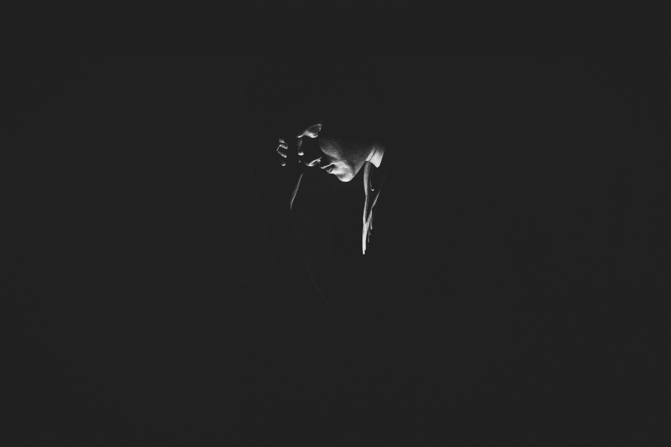 black and white photo, person in profile, dramatically lit, 2K Desktop Wallpaper