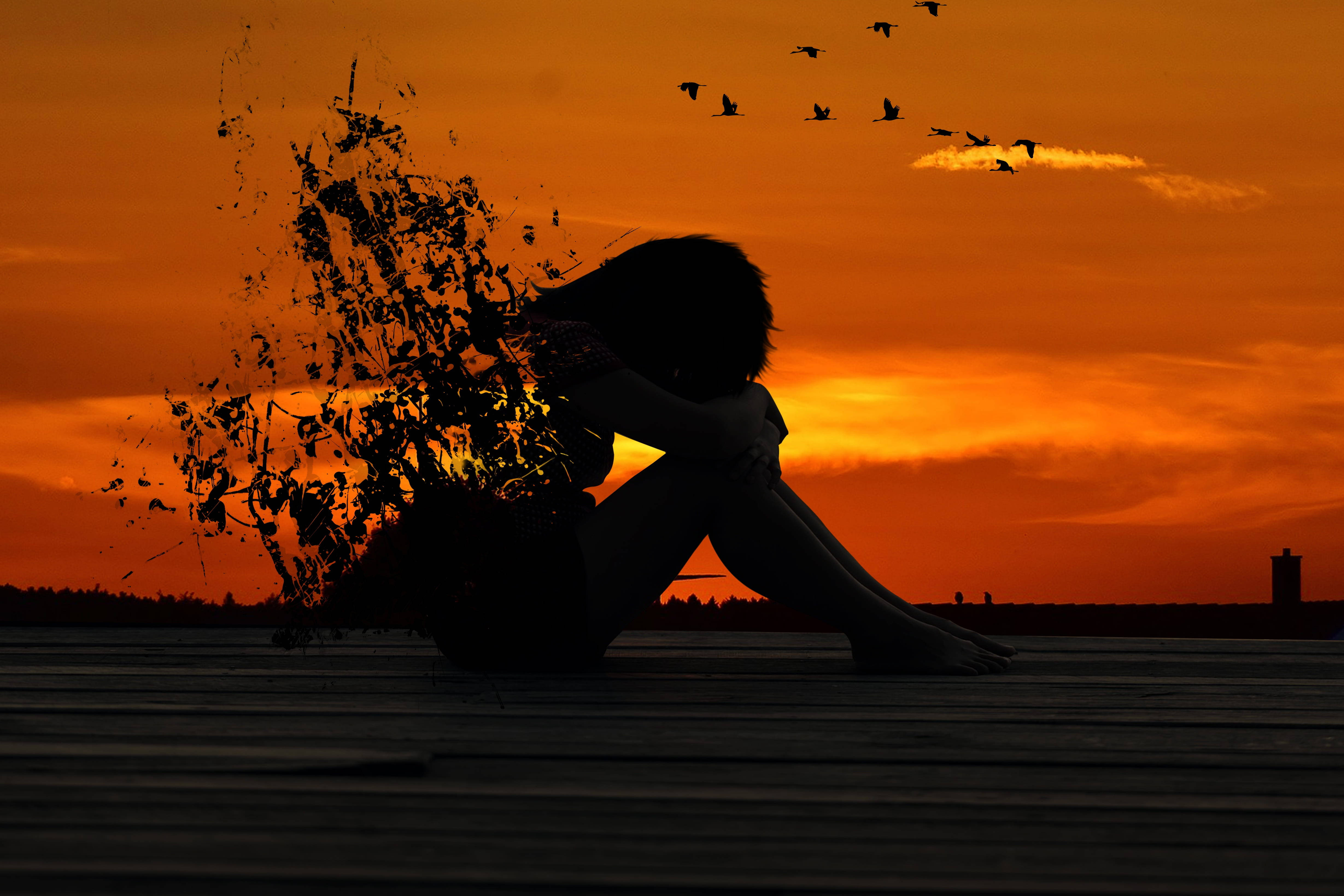 fiery orange sunset sky, silhouette of a person, crumbling into fragments, 4K Desktop Wallpaper