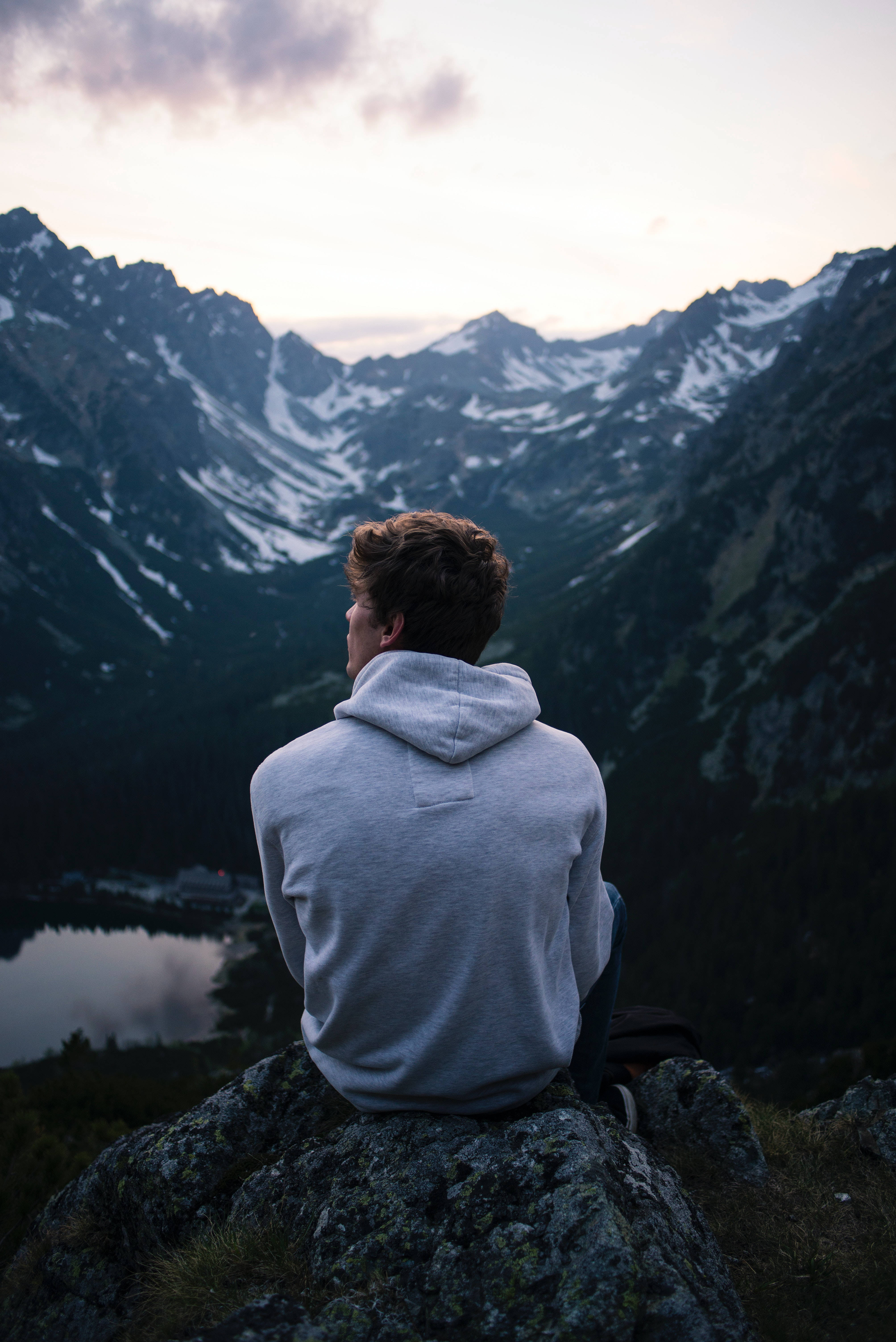 grey hoodie, rocky cliff, snow-dusted mountain valley, 5K Phone Wallpaper
