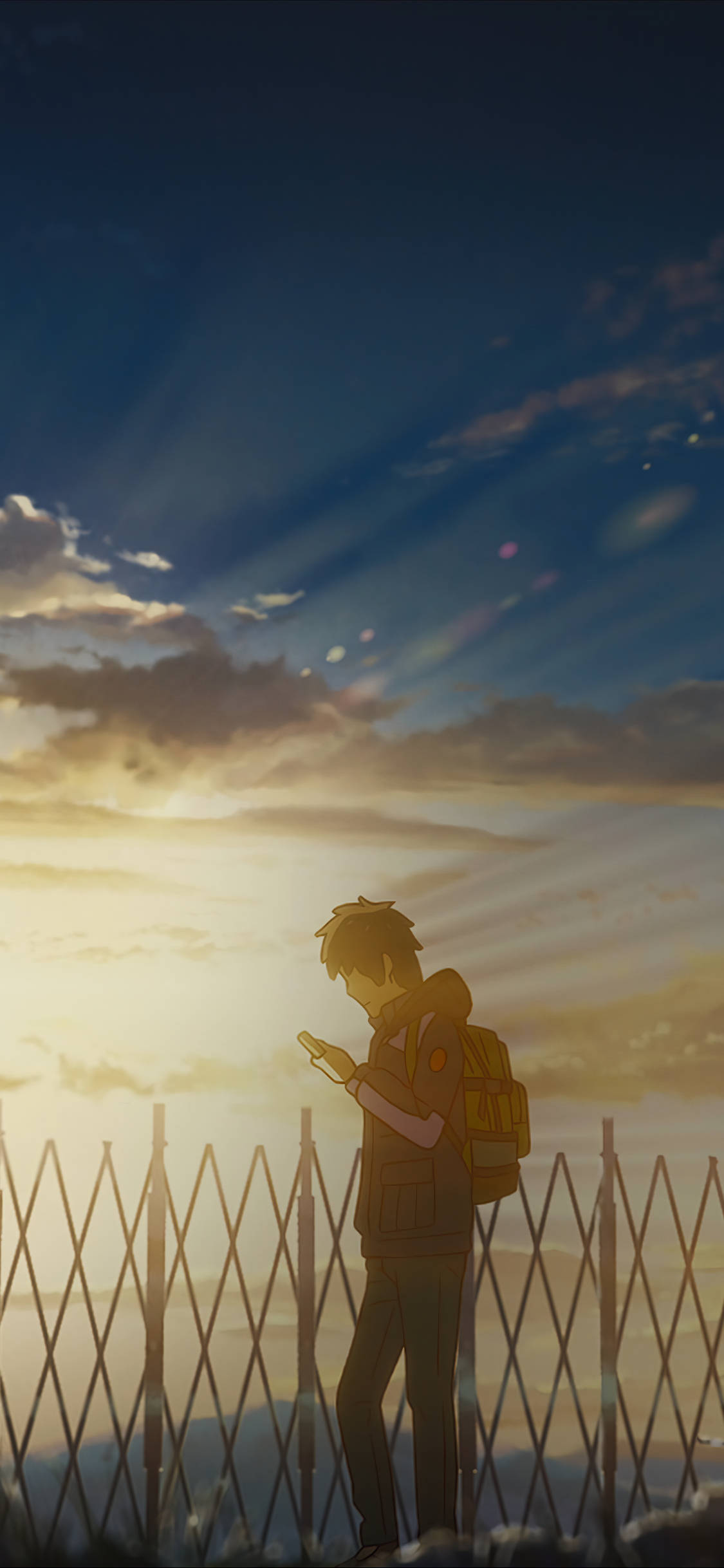 A lone anime boy with a backpack stands by a fence at sunset, bathed in golden light as rays pierce through clouds., Full HD Phone Wallpaper