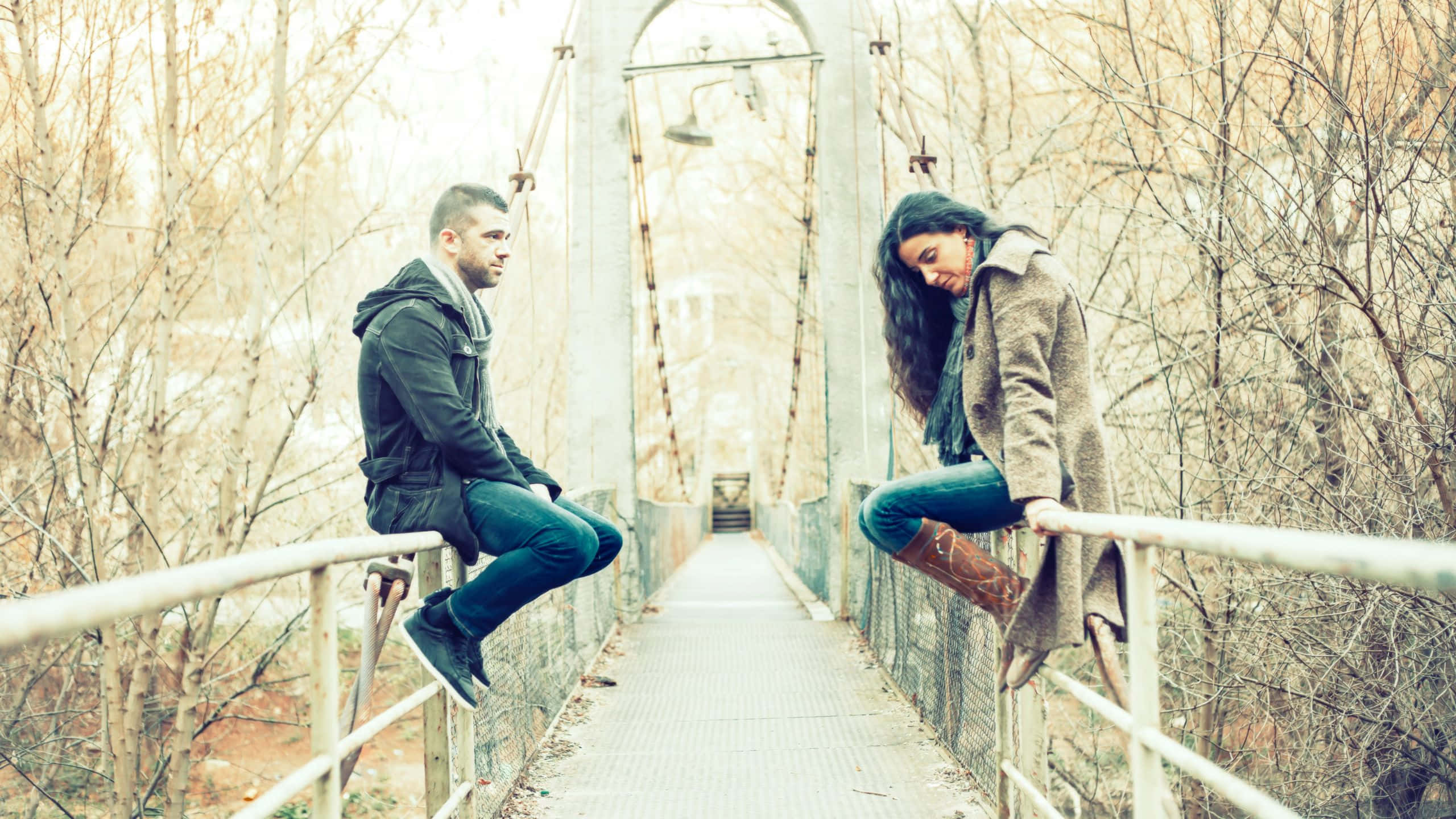 sad couple, weathered suspension bridge, bare trees, 2K Desktop Wallpaper