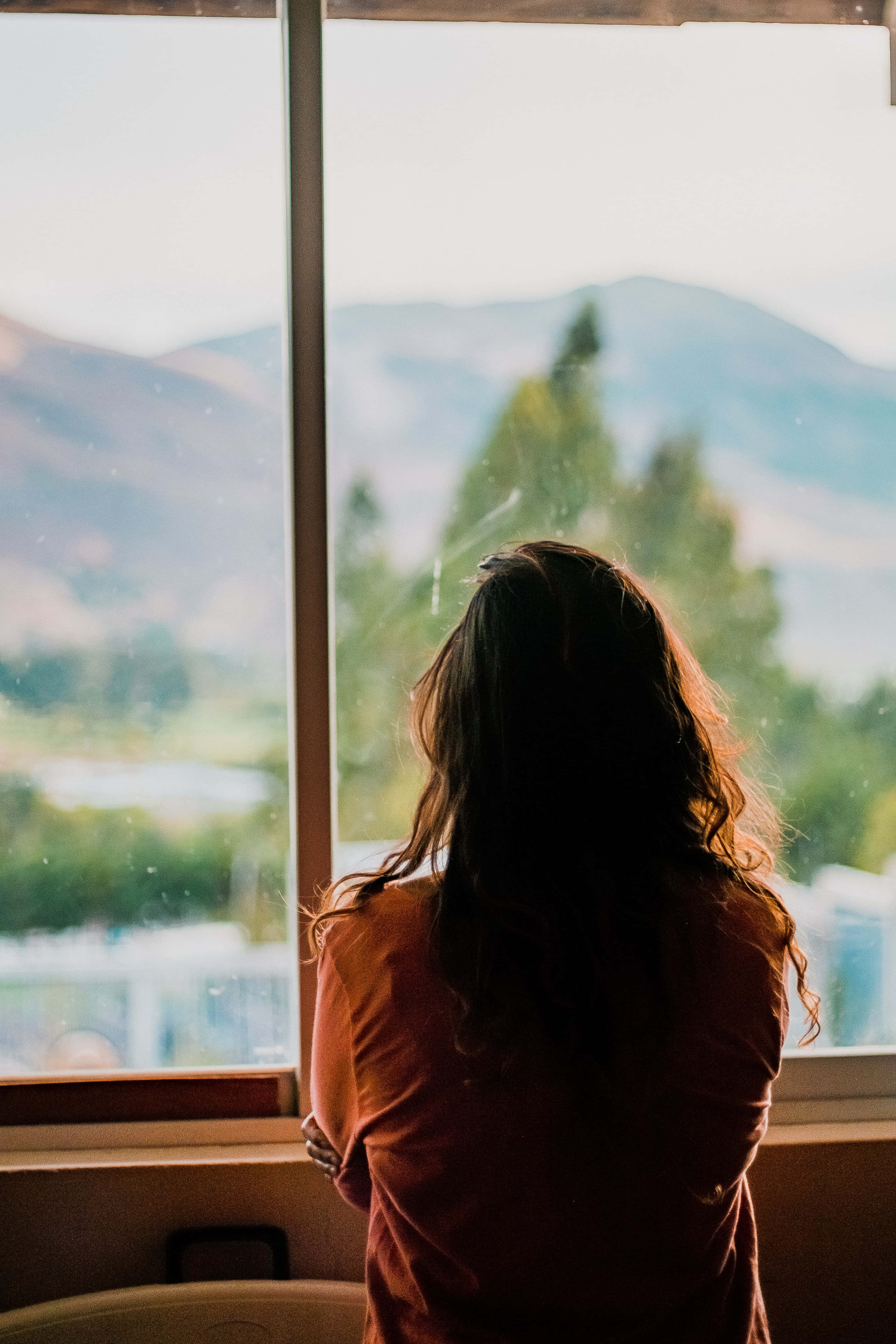 young sad woman, window, orange shirt, 4K Phone Wallpaper