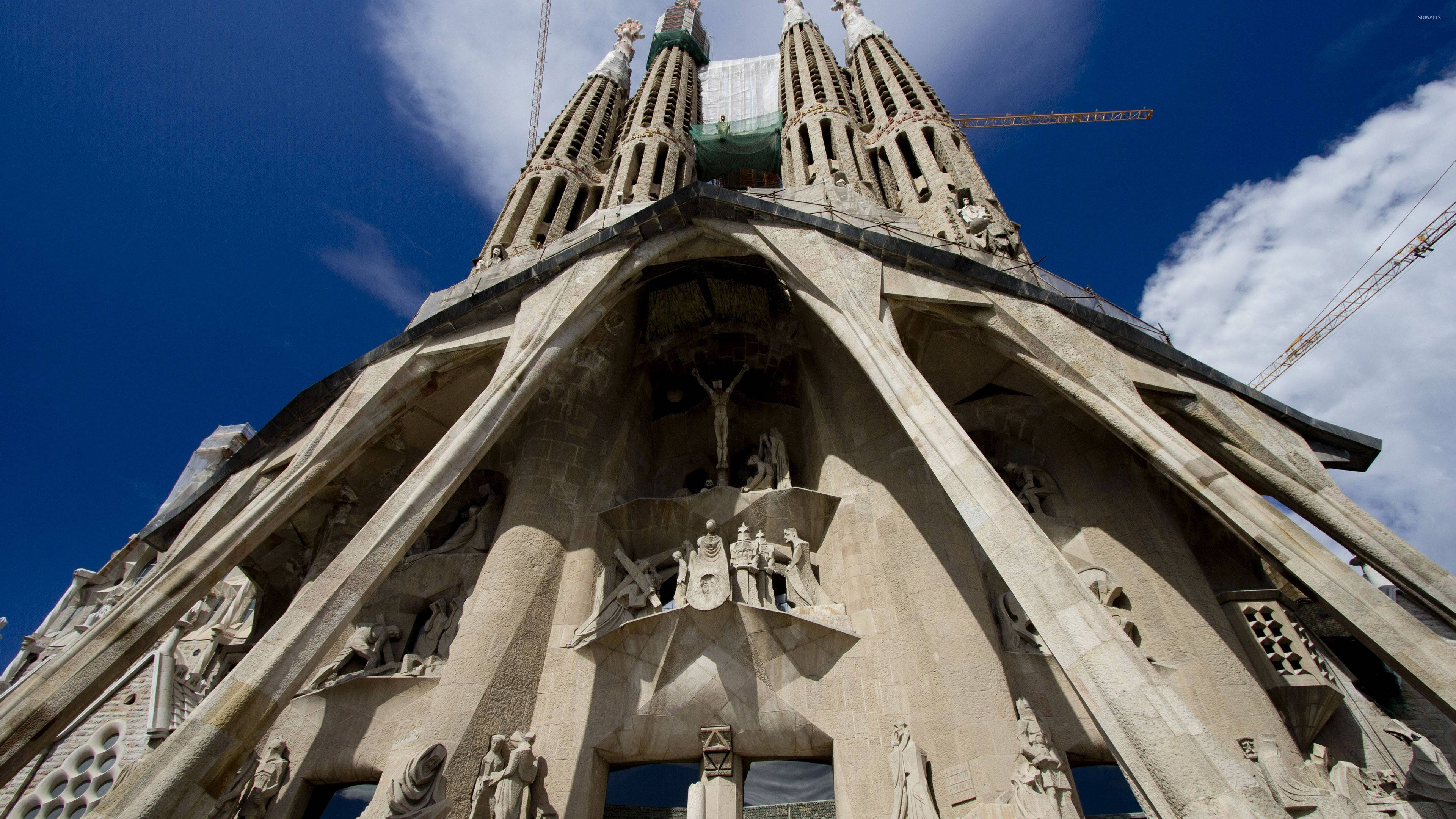 Sagrada Familia, intricate stone facade, vivid blue sky, 4K Desktop Wallpaper