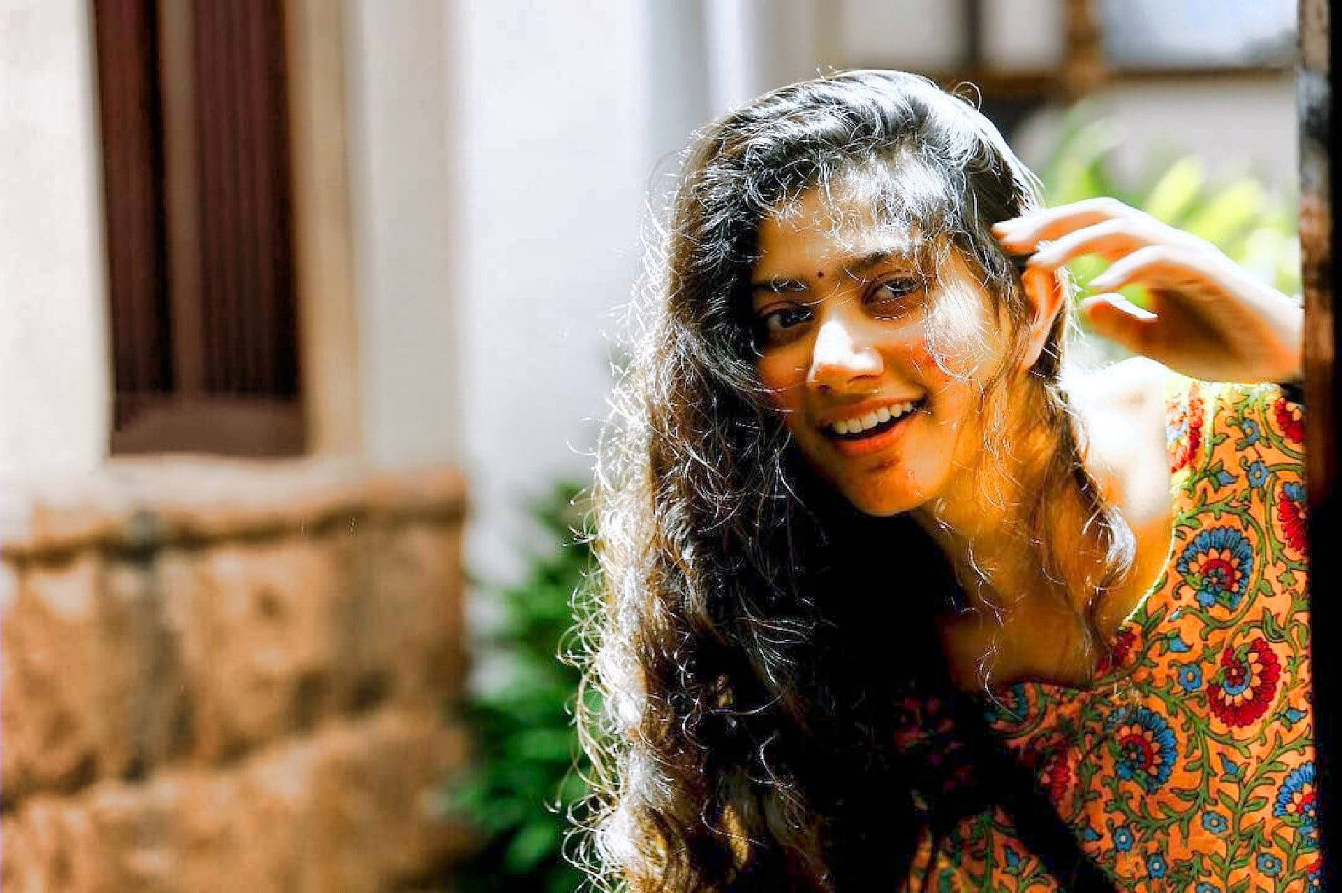 Sai Pallavi, long dark curls, sunlit stone building, Full HD Desktop Wallpaper