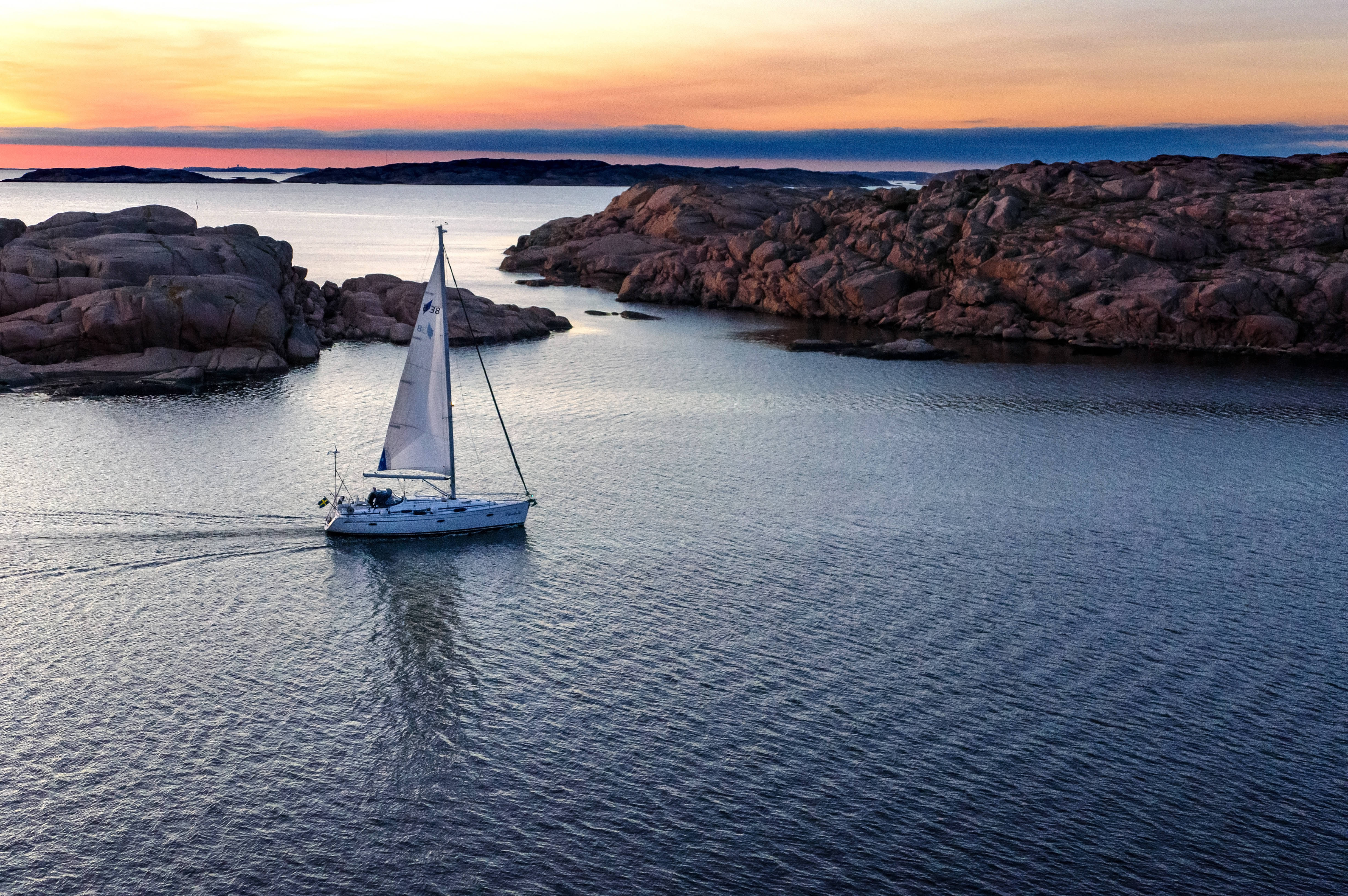 sailboat, rock formation, sunset, 4K Desktop Wallpaper