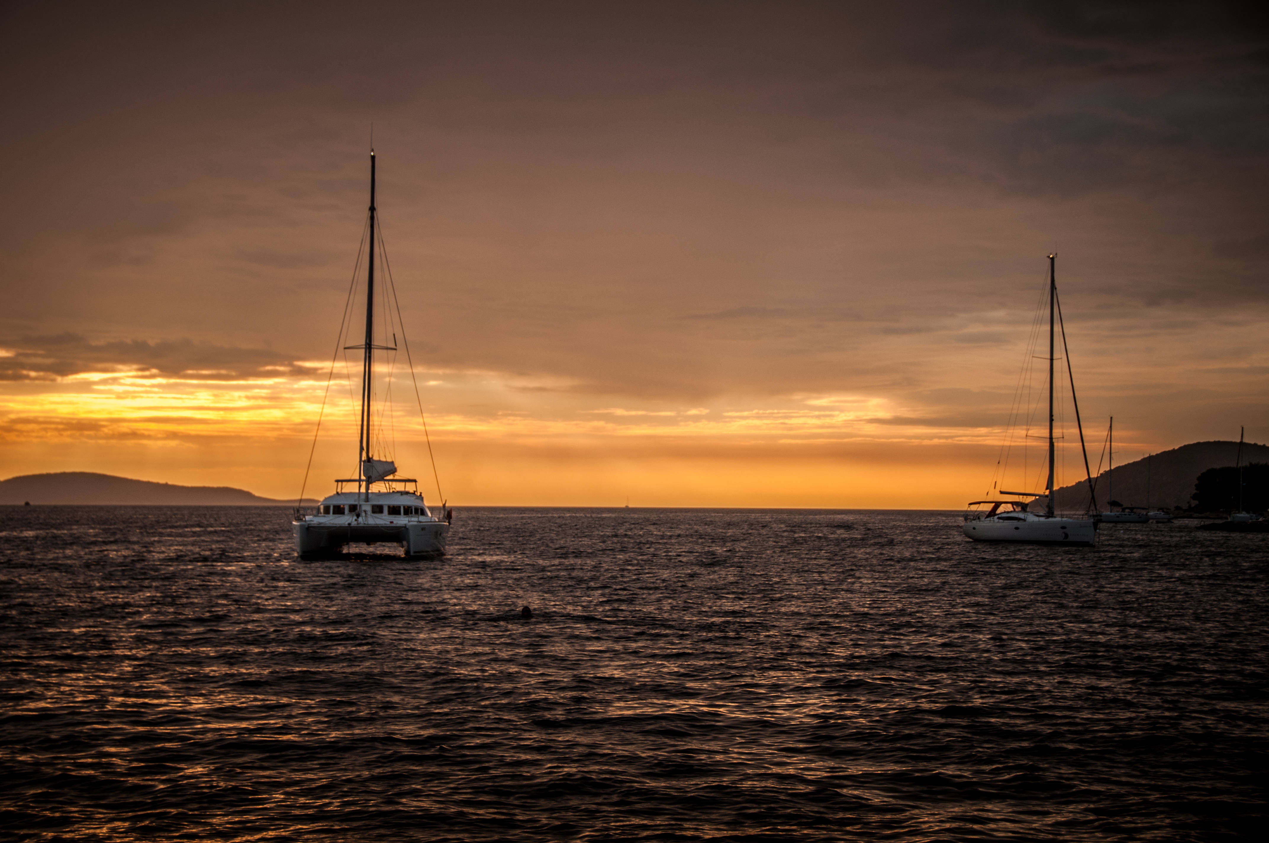 sailing with no sail, fiery orange sunset, calm ocean waters, 4K Desktop Wallpaper