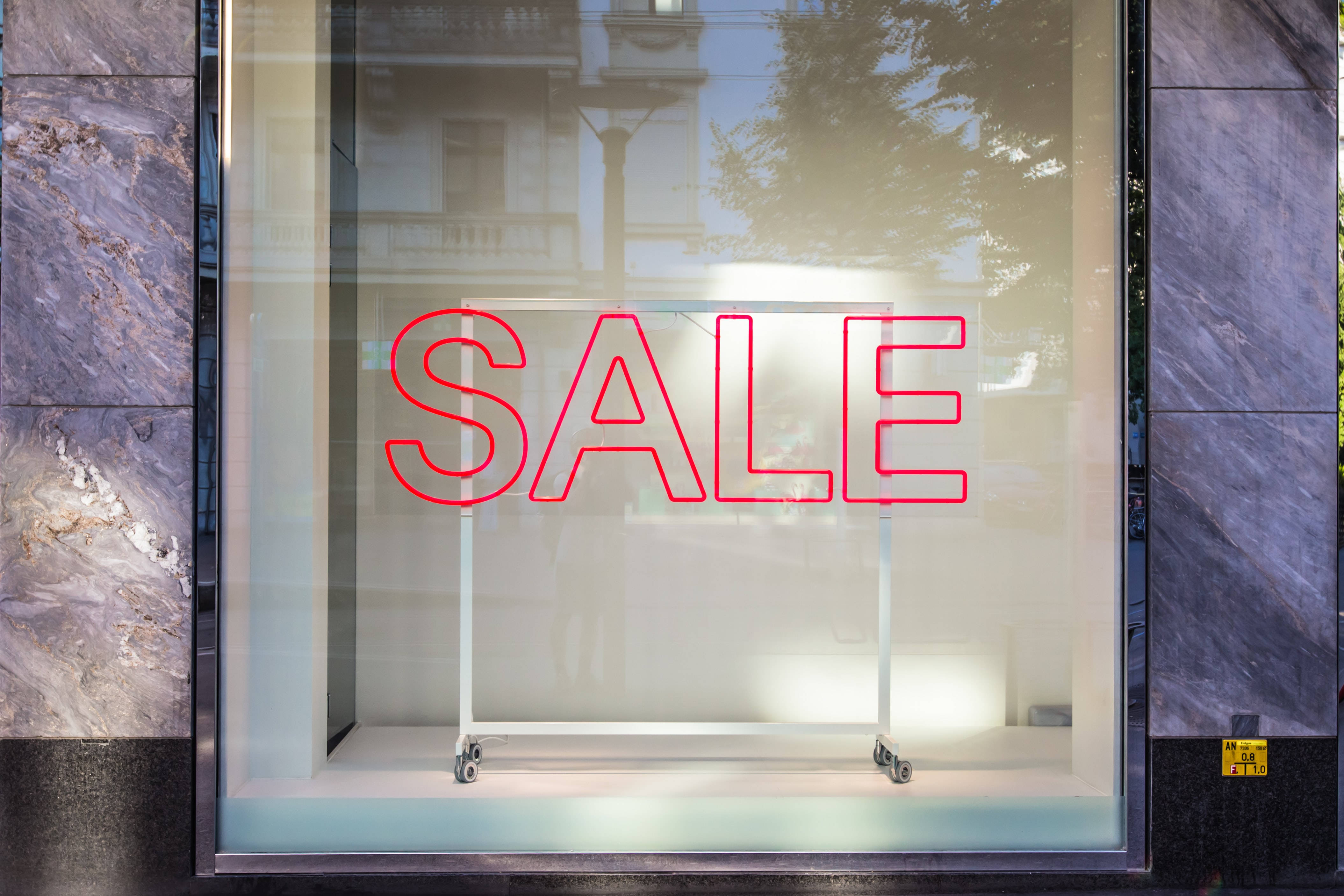 neon SALE sign, sleek glass storefront window, dark marble, 4K Desktop Wallpaper