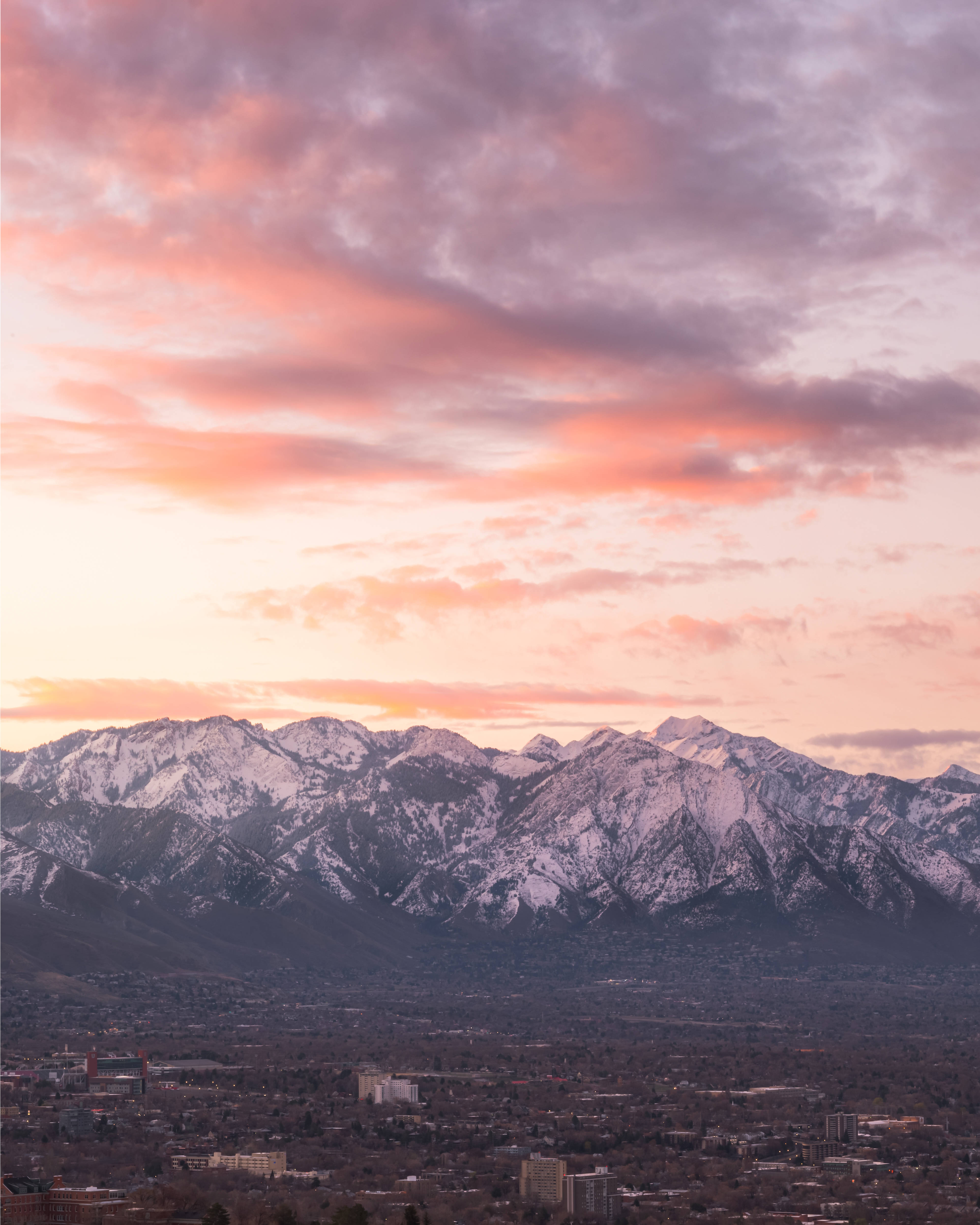 Salt Lake City, snow-covered mountains, vibrant pink and orange sunset sky, 4K Phone Wallpaper