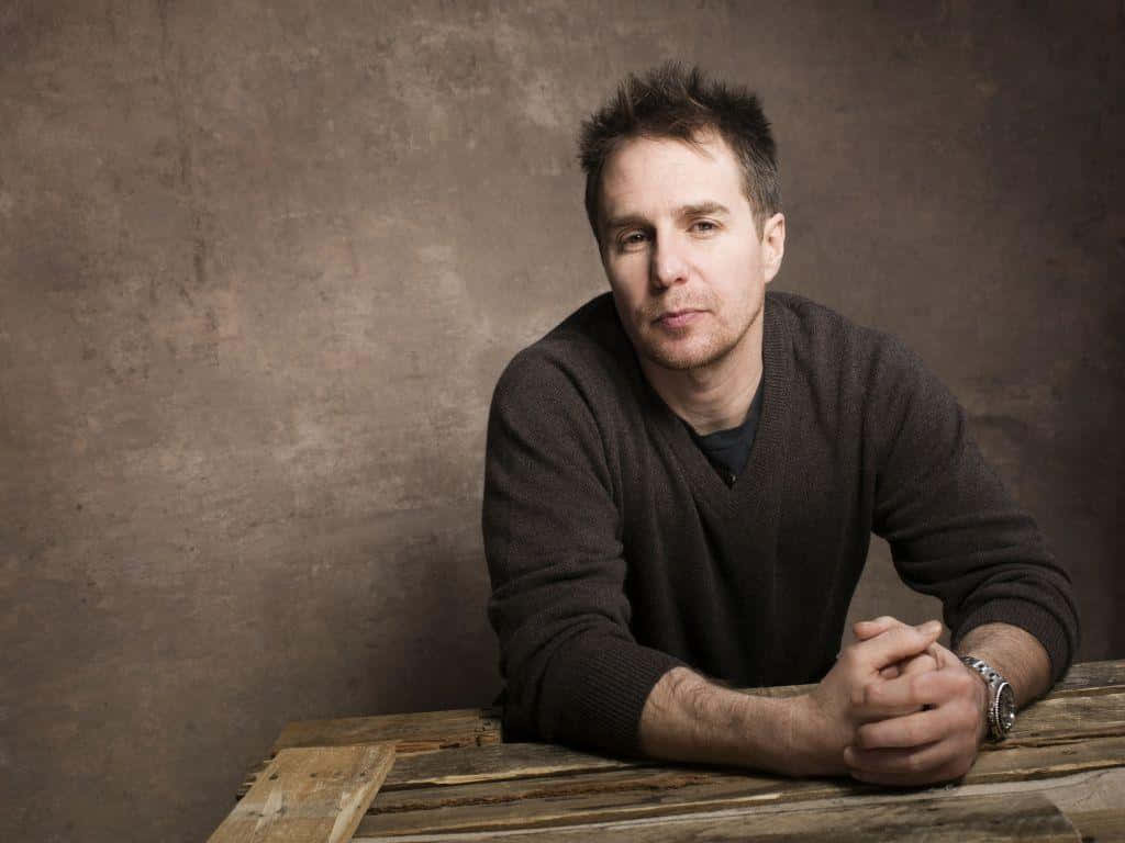 Sam Rockwell, dark sweater, wooden table, SD Desktop Wallpaper